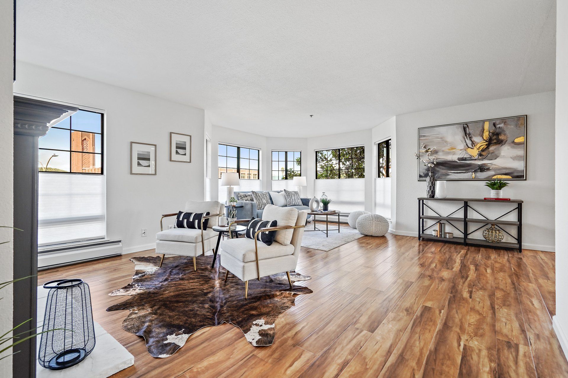 A living room with hardwood floors and a cowhide rug.