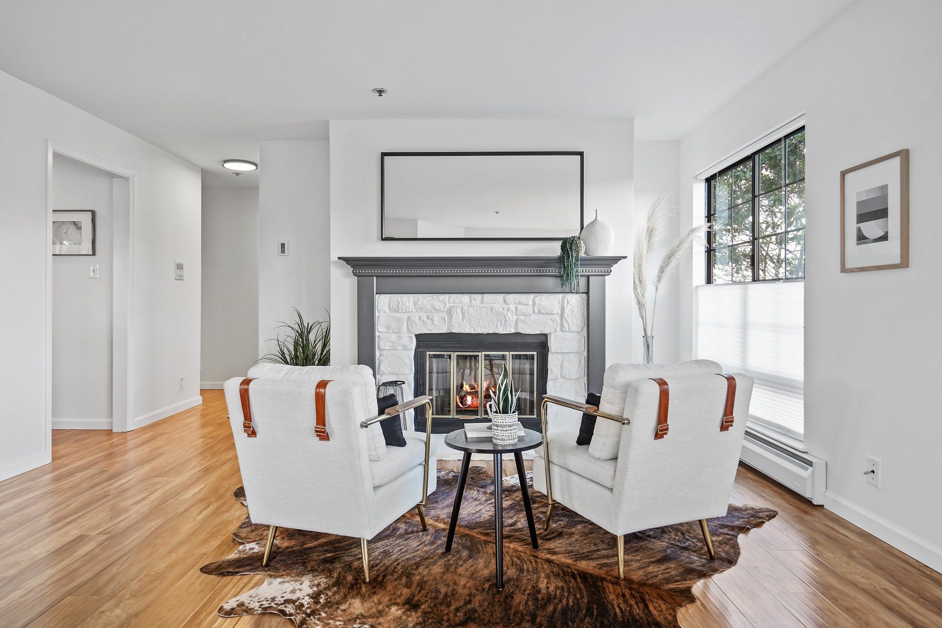 A living room with two chairs and a fireplace.