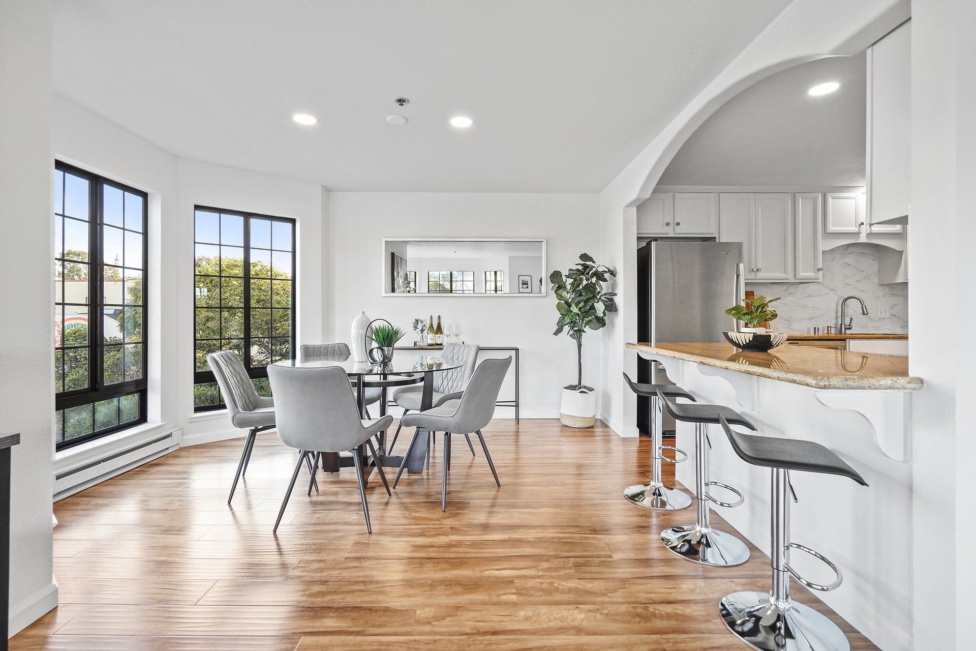 A dining room with a table and chairs and a kitchen