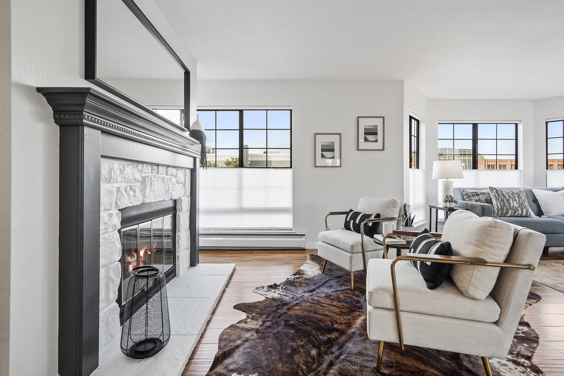 A living room with a fireplace , couch , chair and rug.