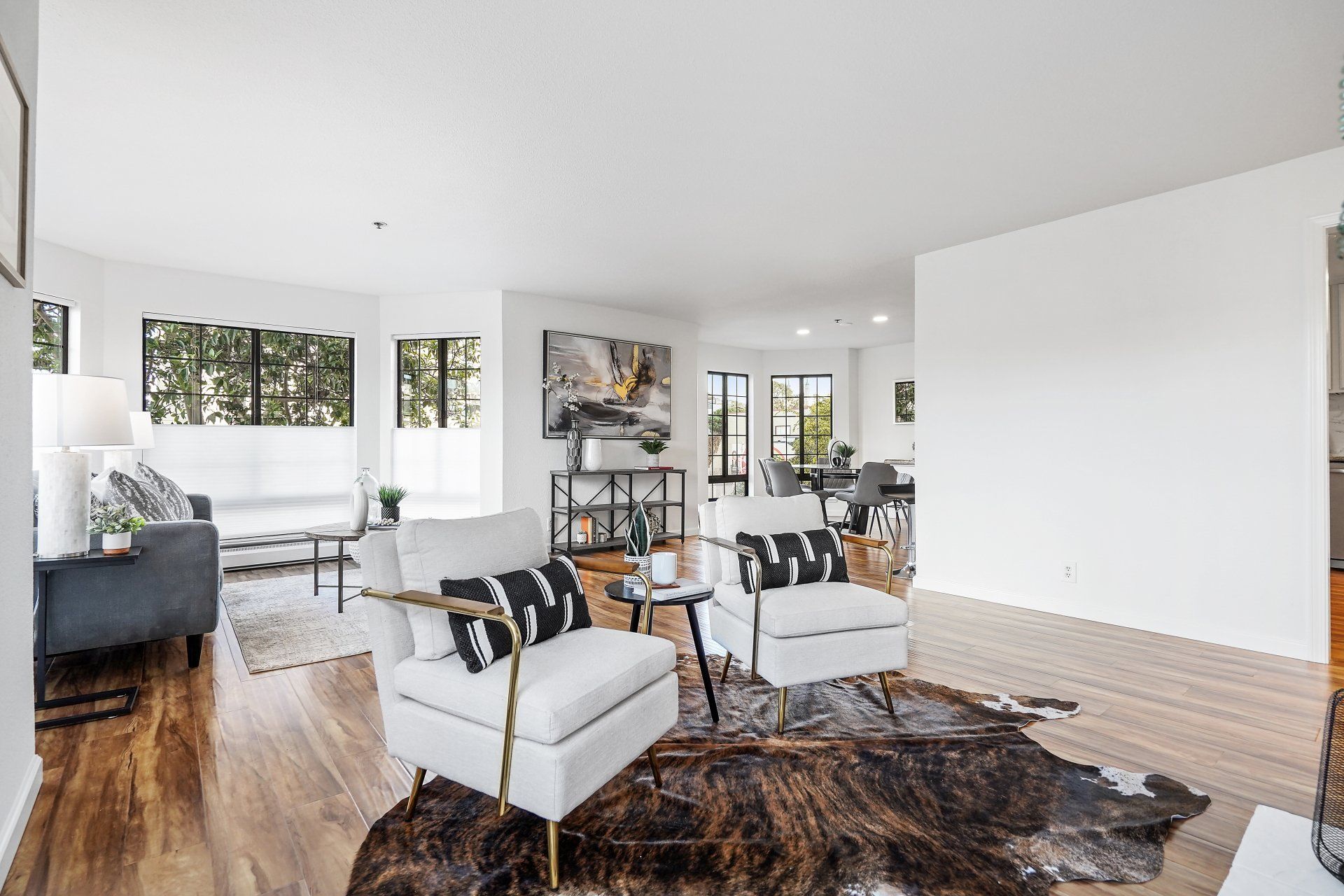 A living room with two chairs and a cowhide rug