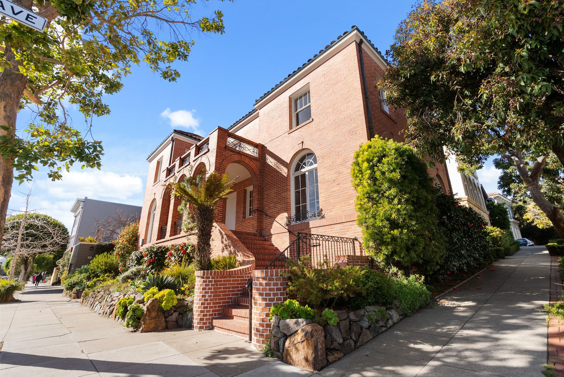 A large brick house with stairs leading up to it