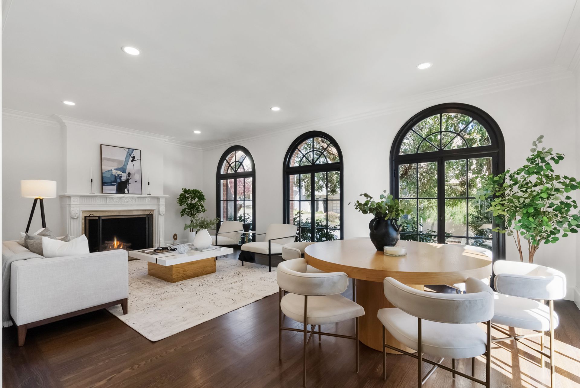 A living room with a table and chairs and a fireplace