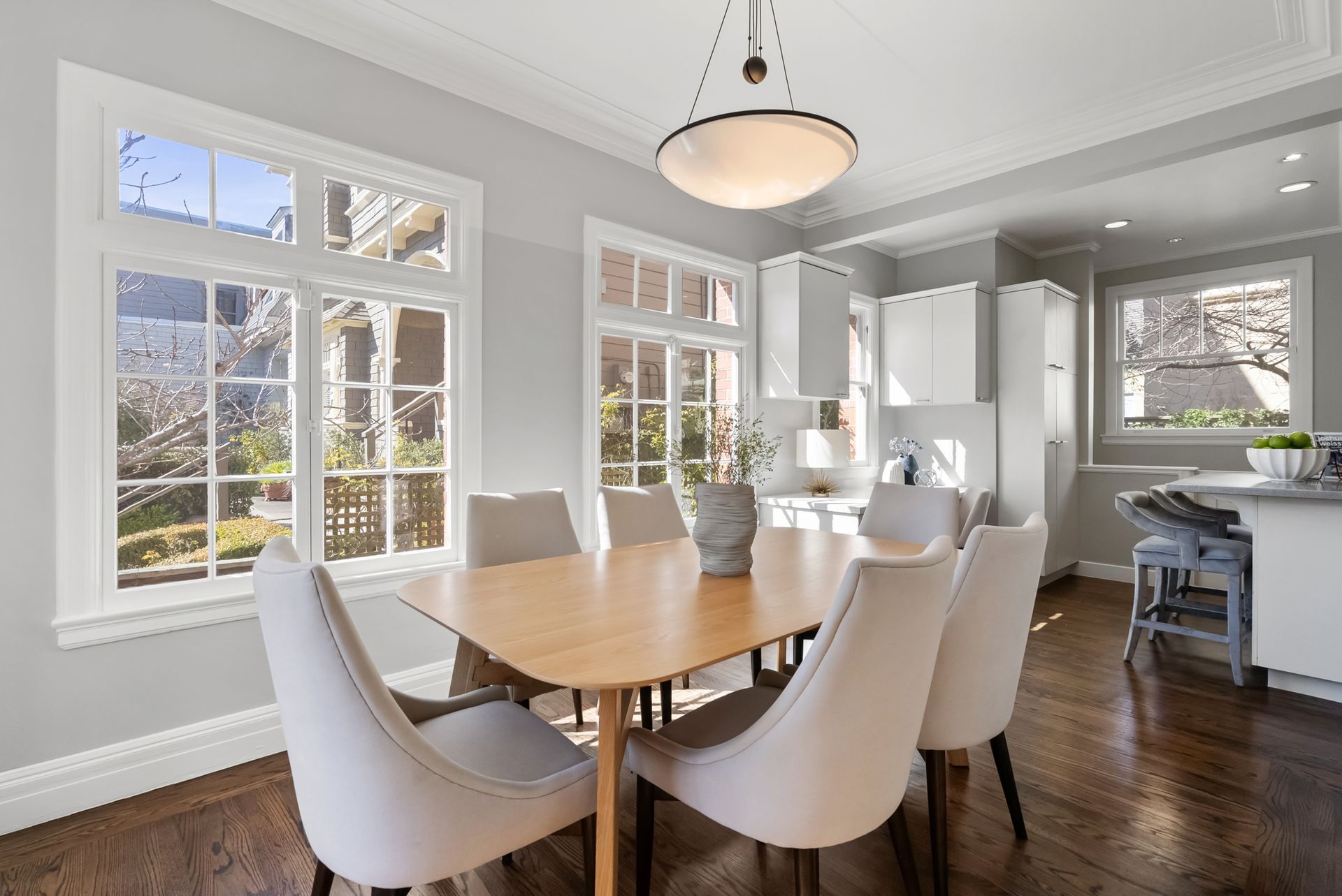 A dining room with a table and chairs and a chandelier.