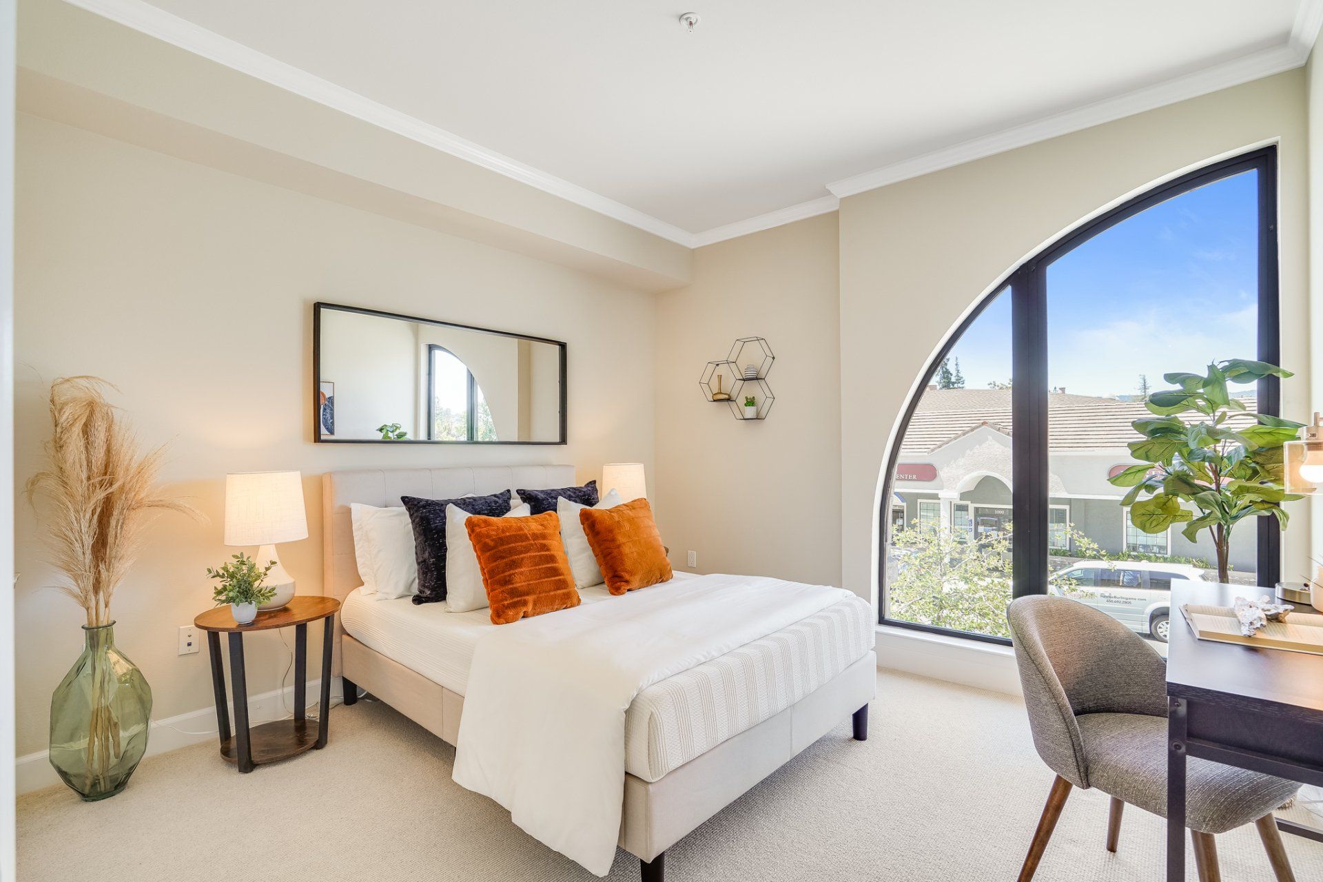 A bedroom with a large bed and a large window