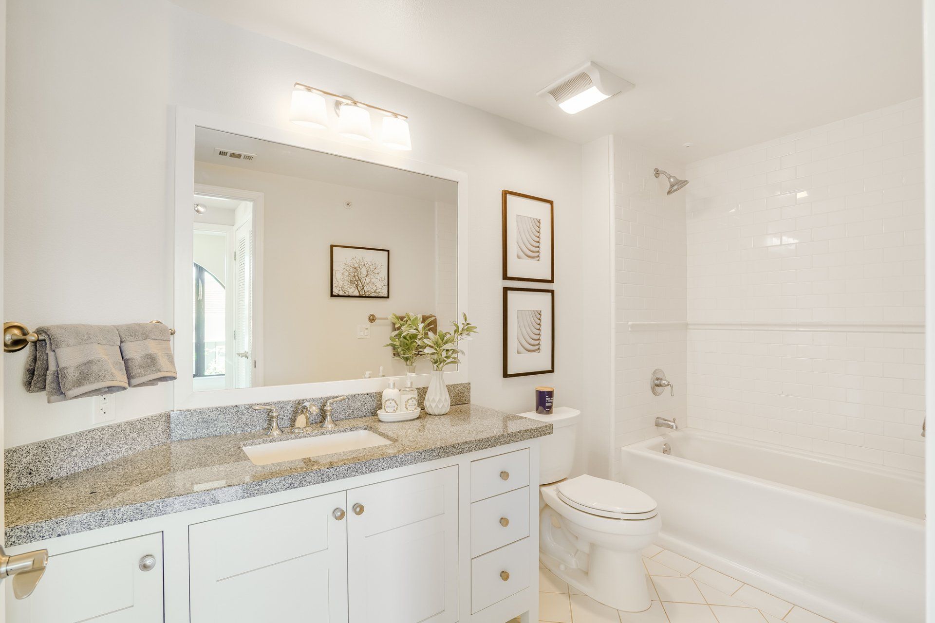 A bathroom with a toilet , sink , and bathtub