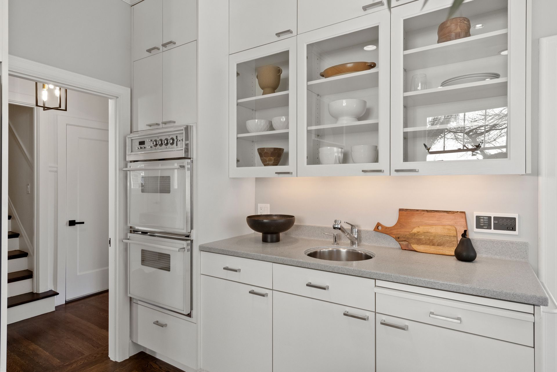 A kitchen with white cabinets and stainless steel appliances