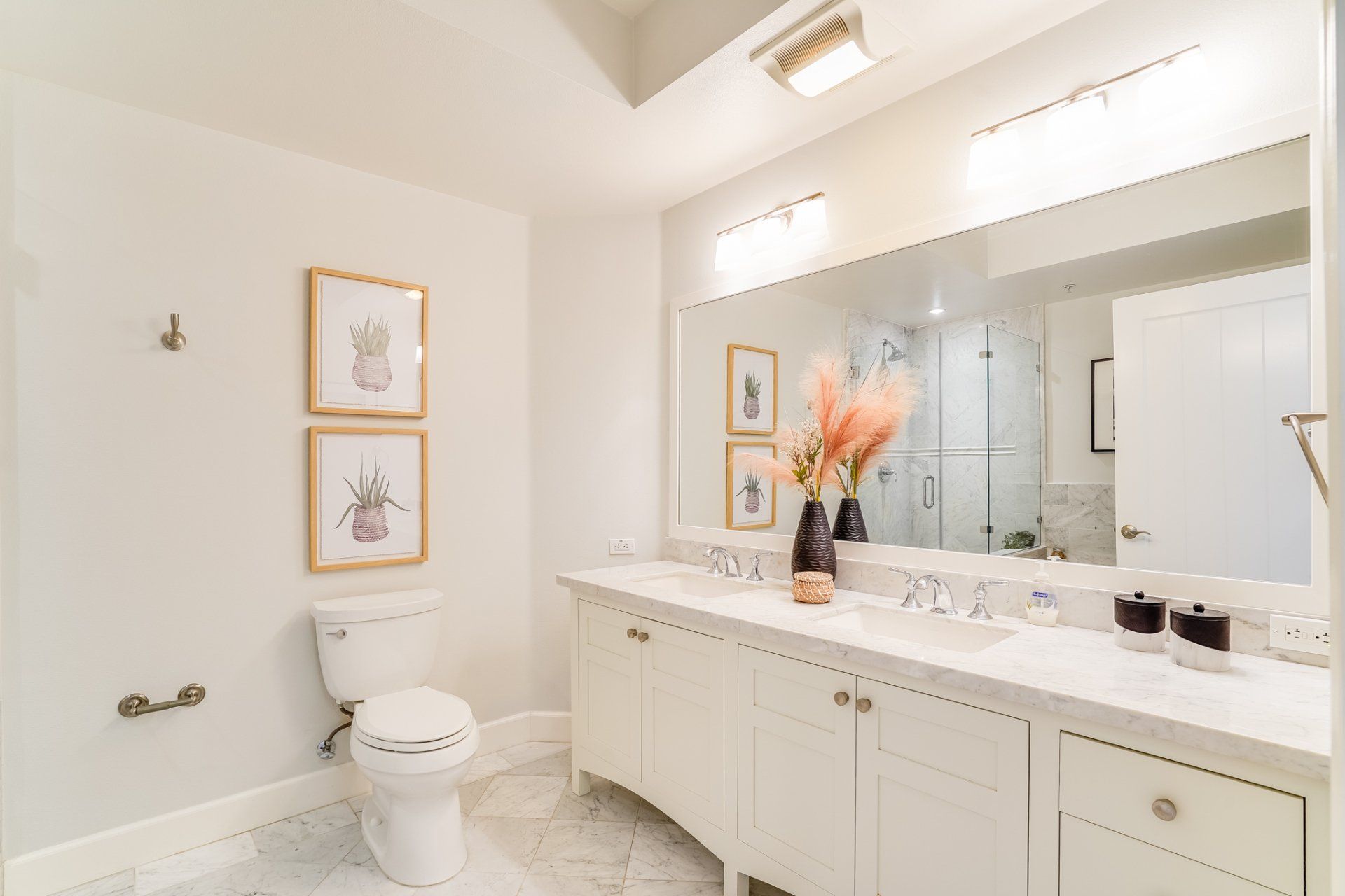 A bathroom with a toilet , sink , and mirror.