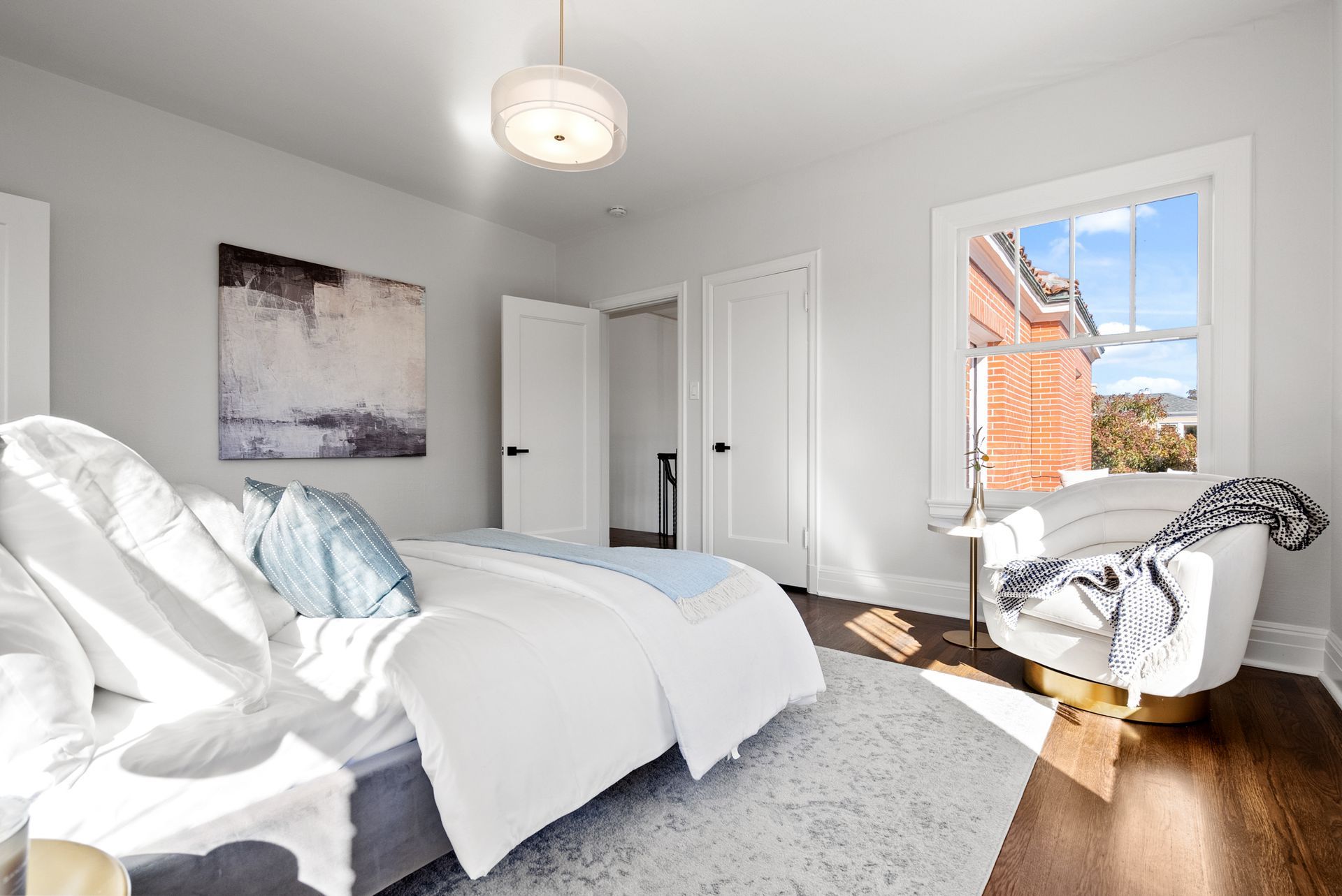 A bedroom with a bed and a chair