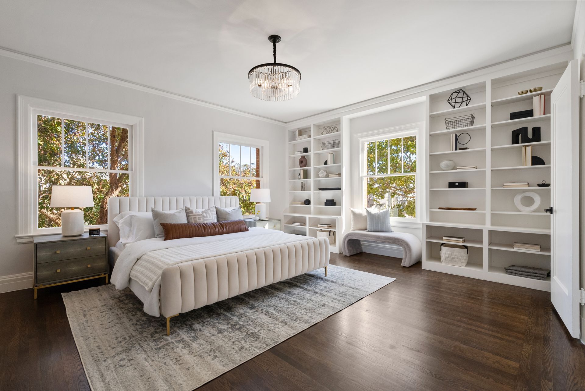 A bedroom with a large bed and lots of shelves