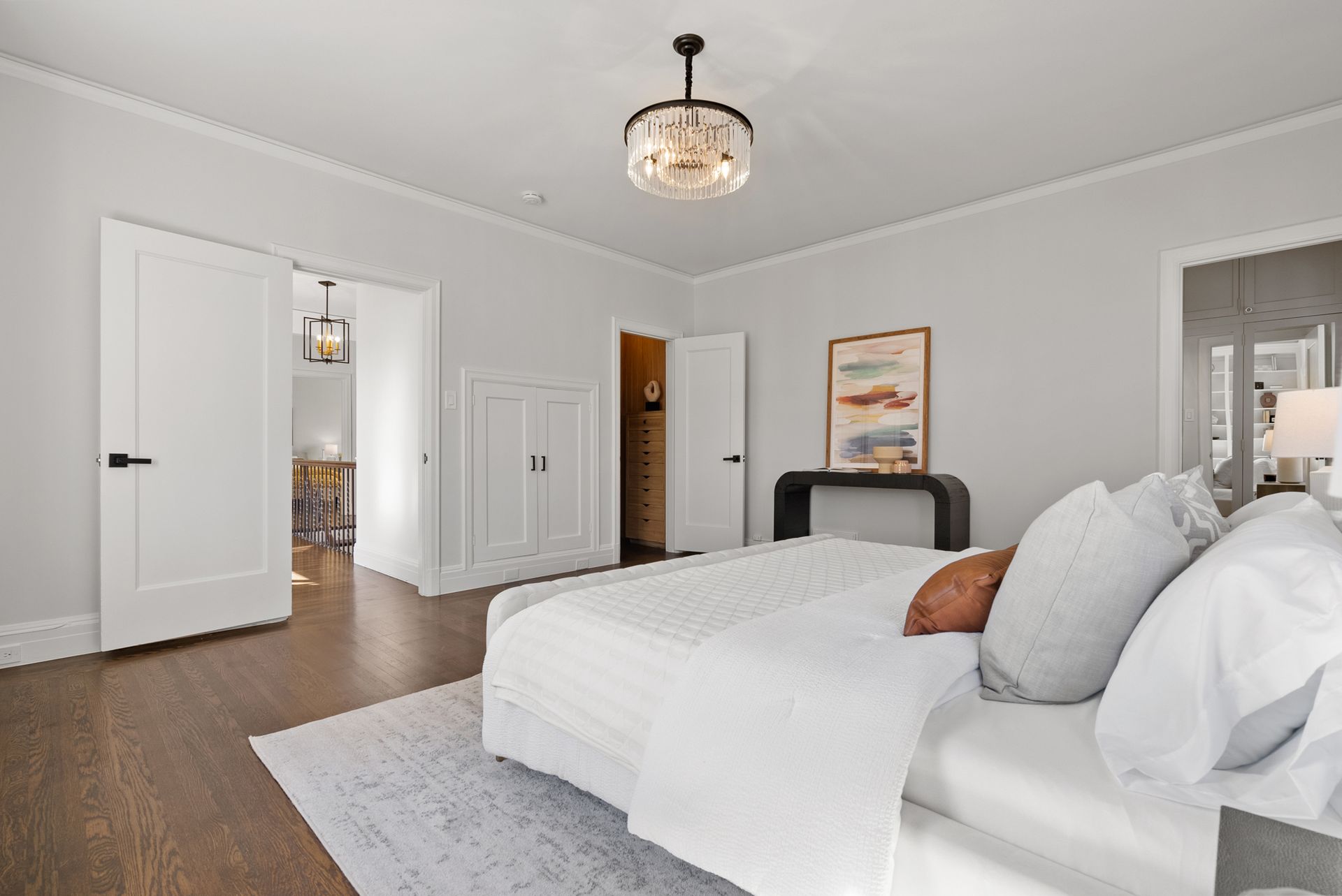 A bedroom with a bed and a ceiling light