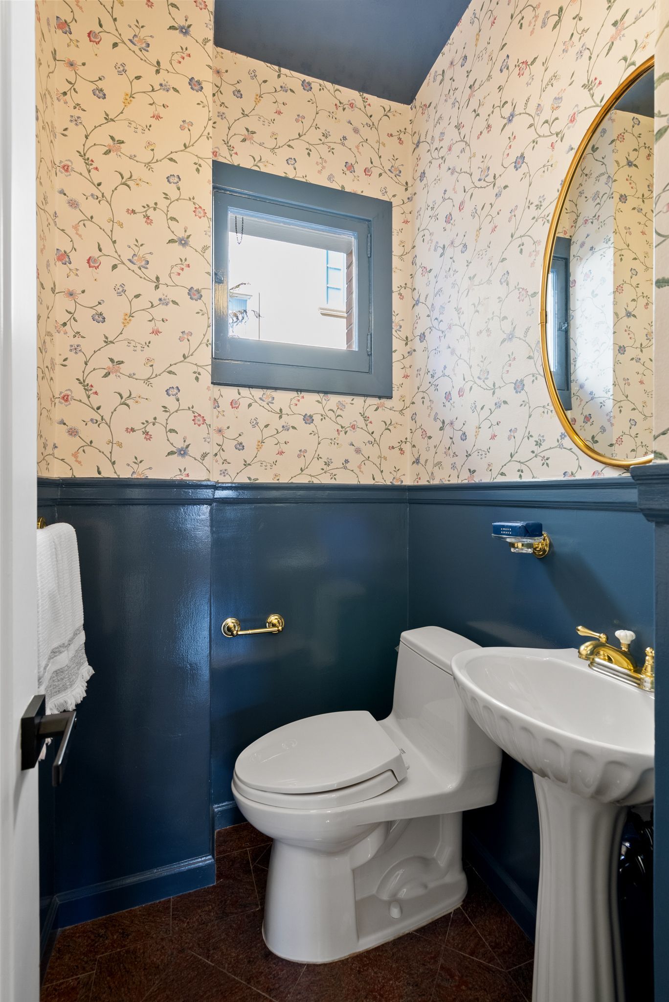 A bathroom with a toilet , sink and mirror