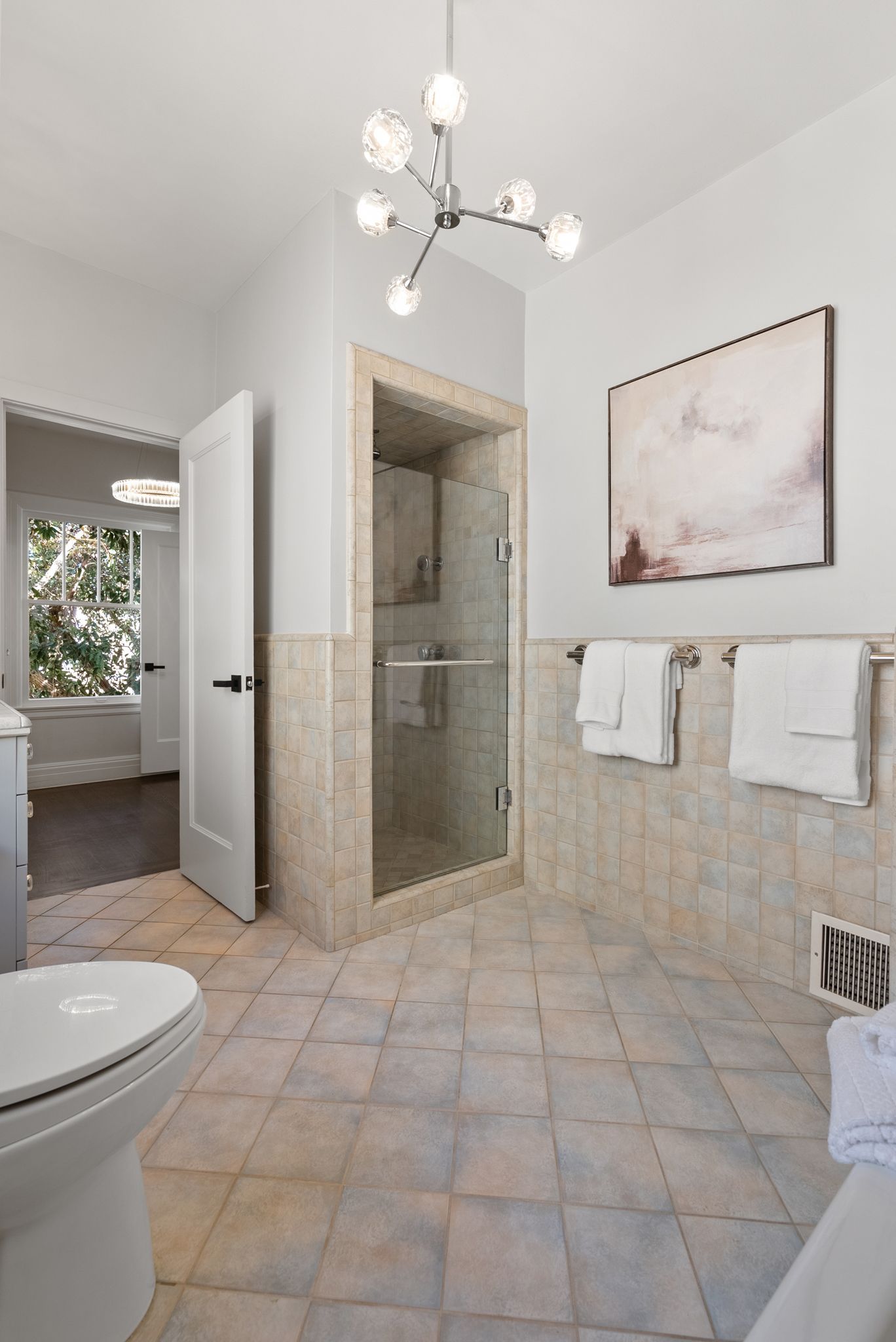 A bathroom with a toilet a bathtub and a shower