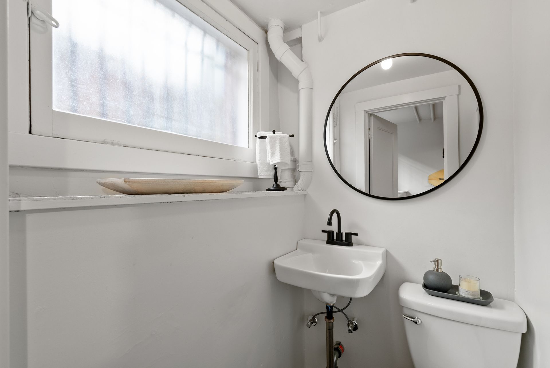 A bathroom with a sink , toilet and mirror