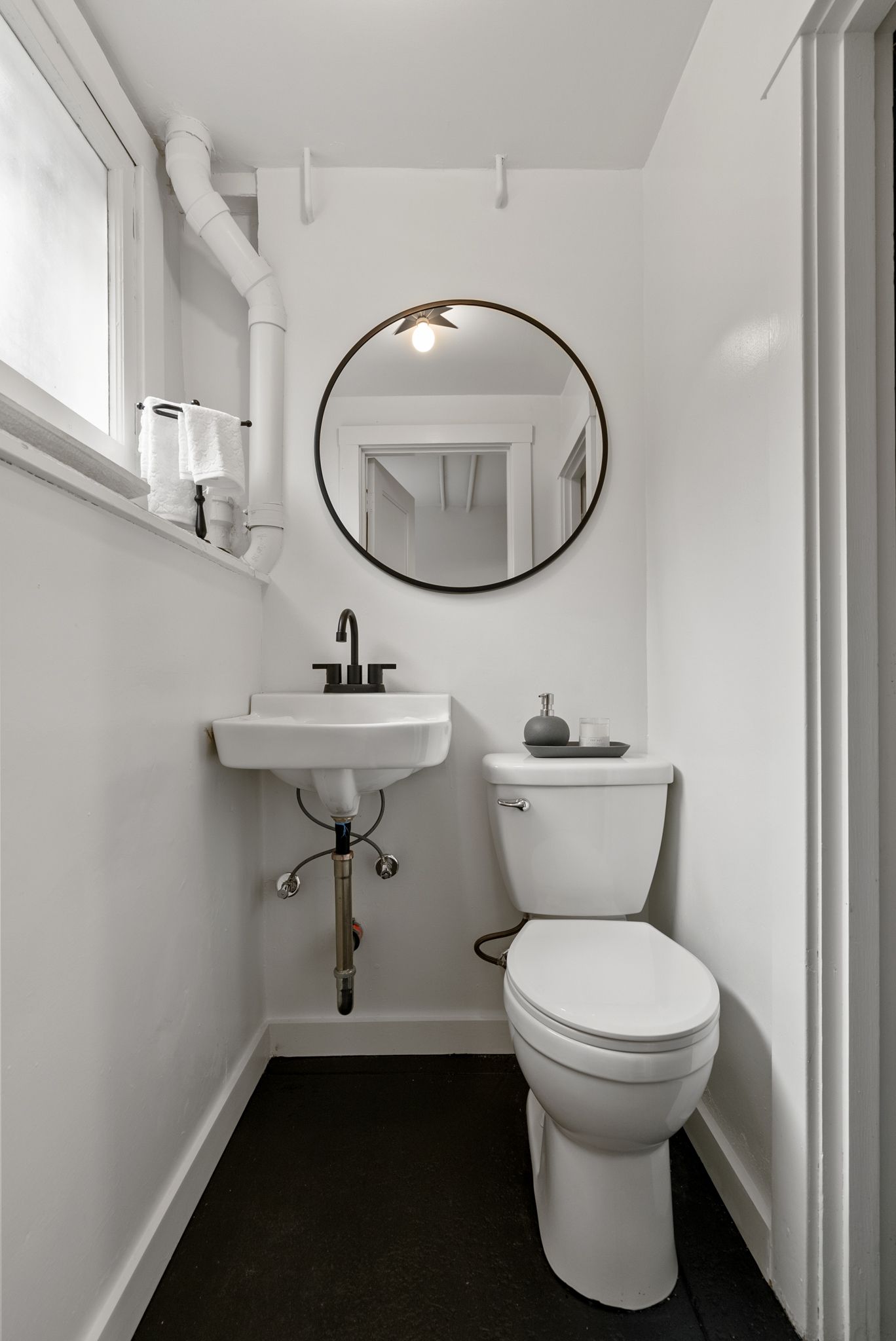 A bathroom with a toilet , sink and mirror