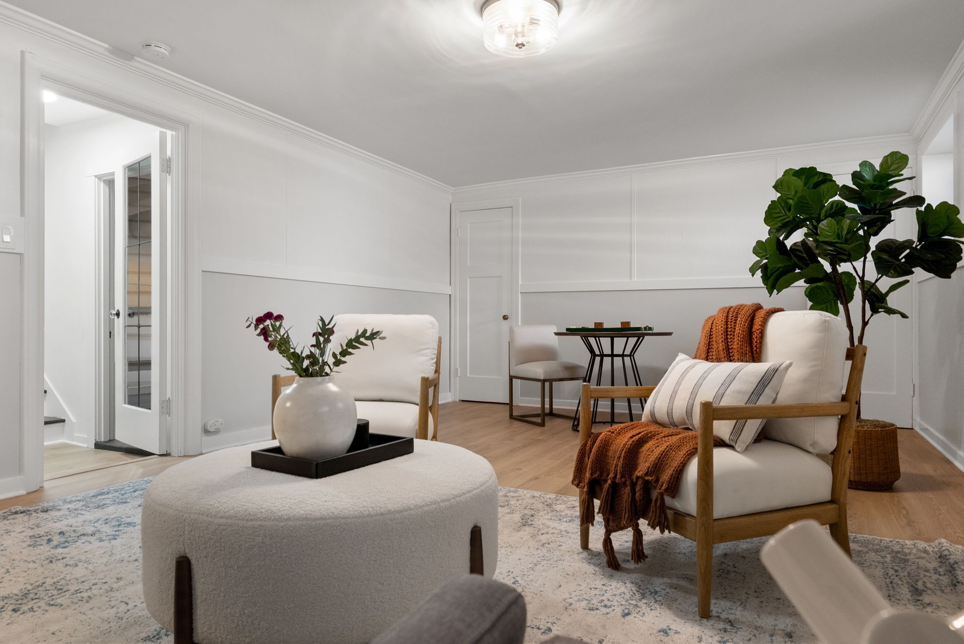 A living room with two chairs and an ottoman