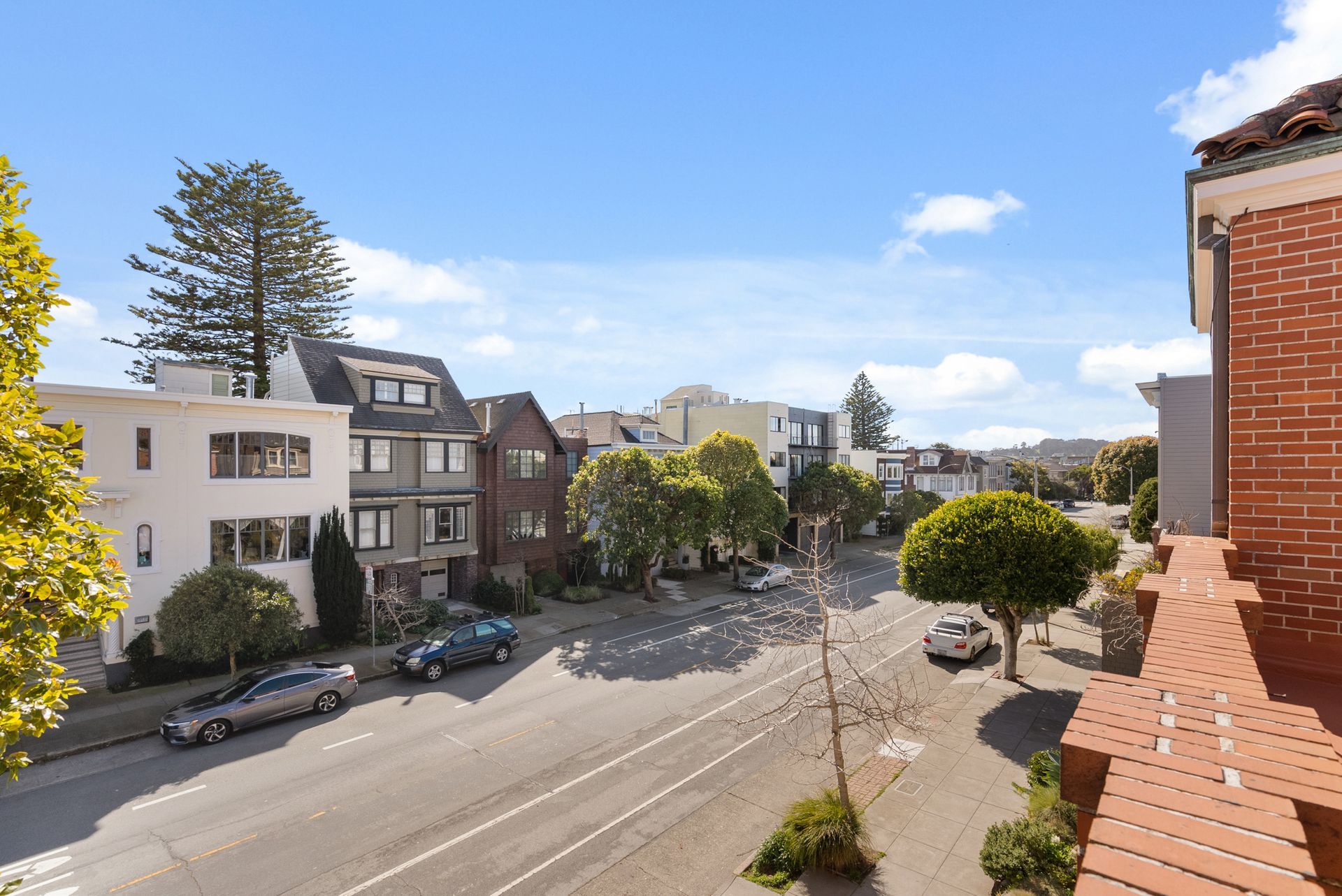 A view of a city street from a balcony.