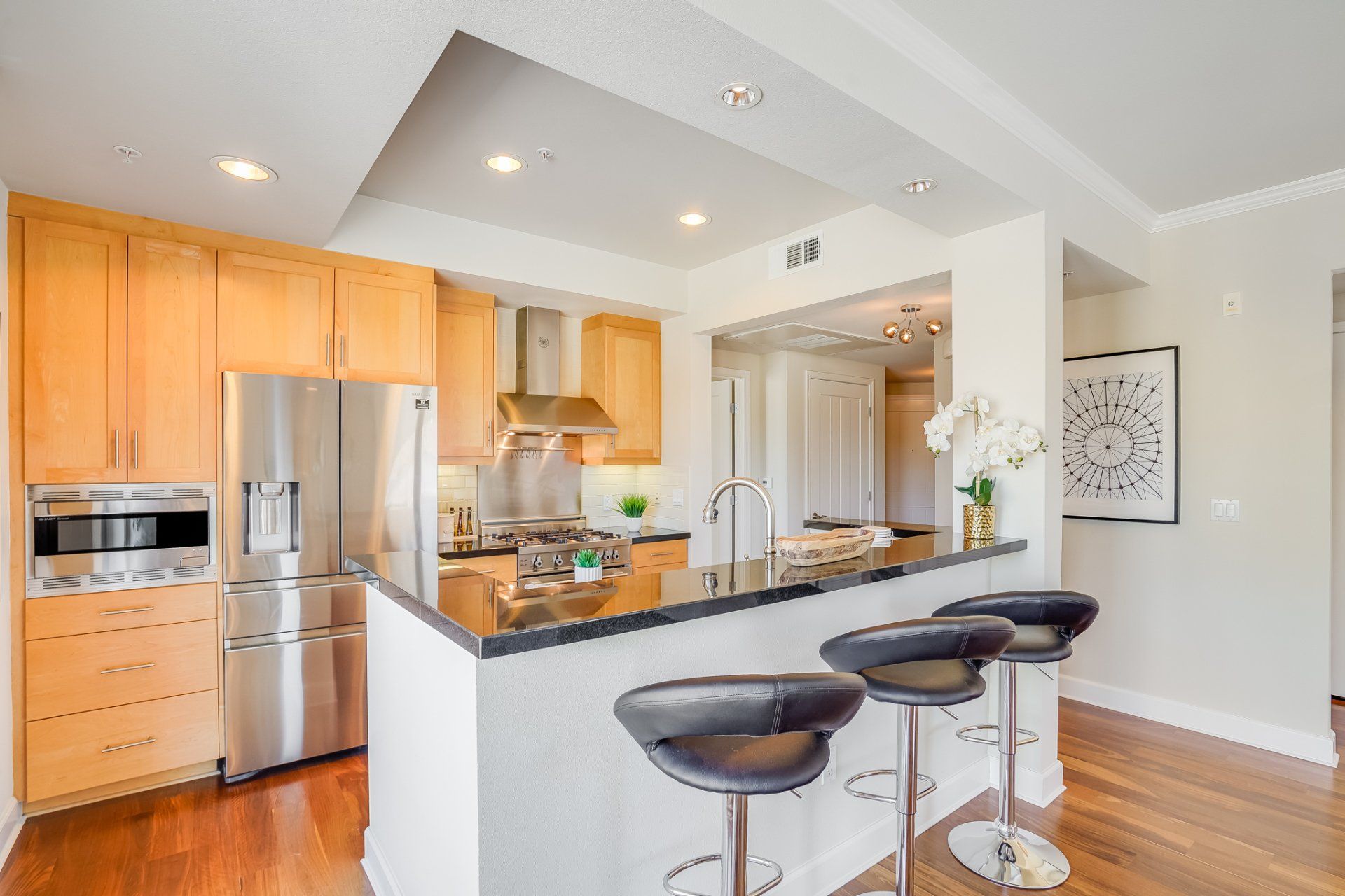 A kitchen with stainless steel appliances and wooden cabinets