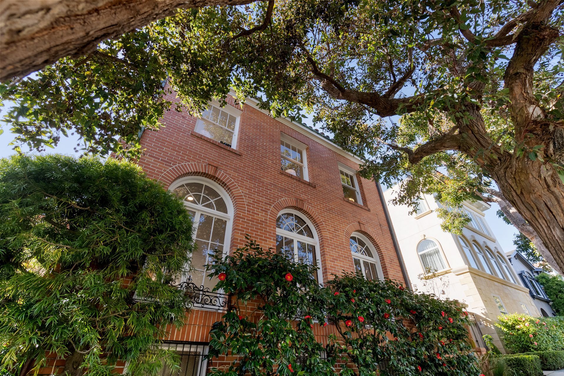 A large brick building with a tree in front of it.