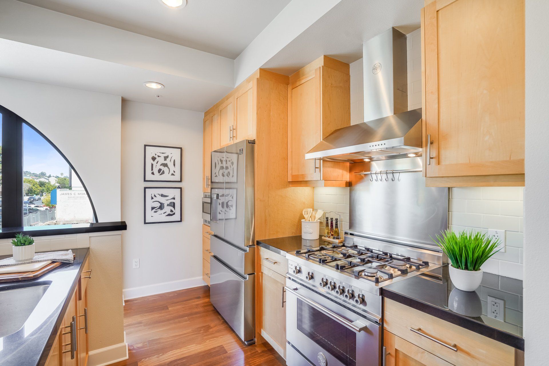 A kitchen with stainless steel appliances and wooden cabinets