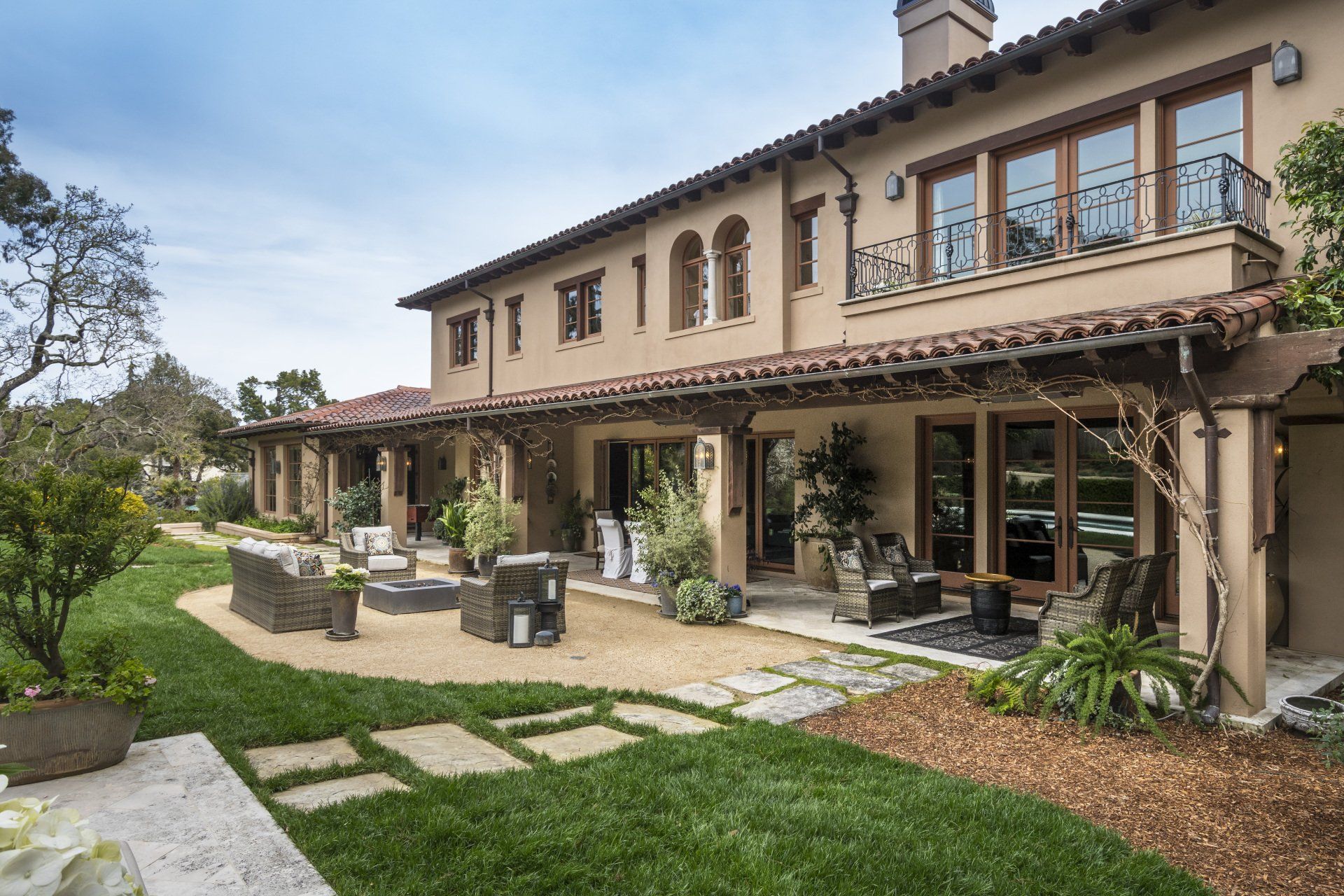 A large house with a lot of windows and a patio in front of it