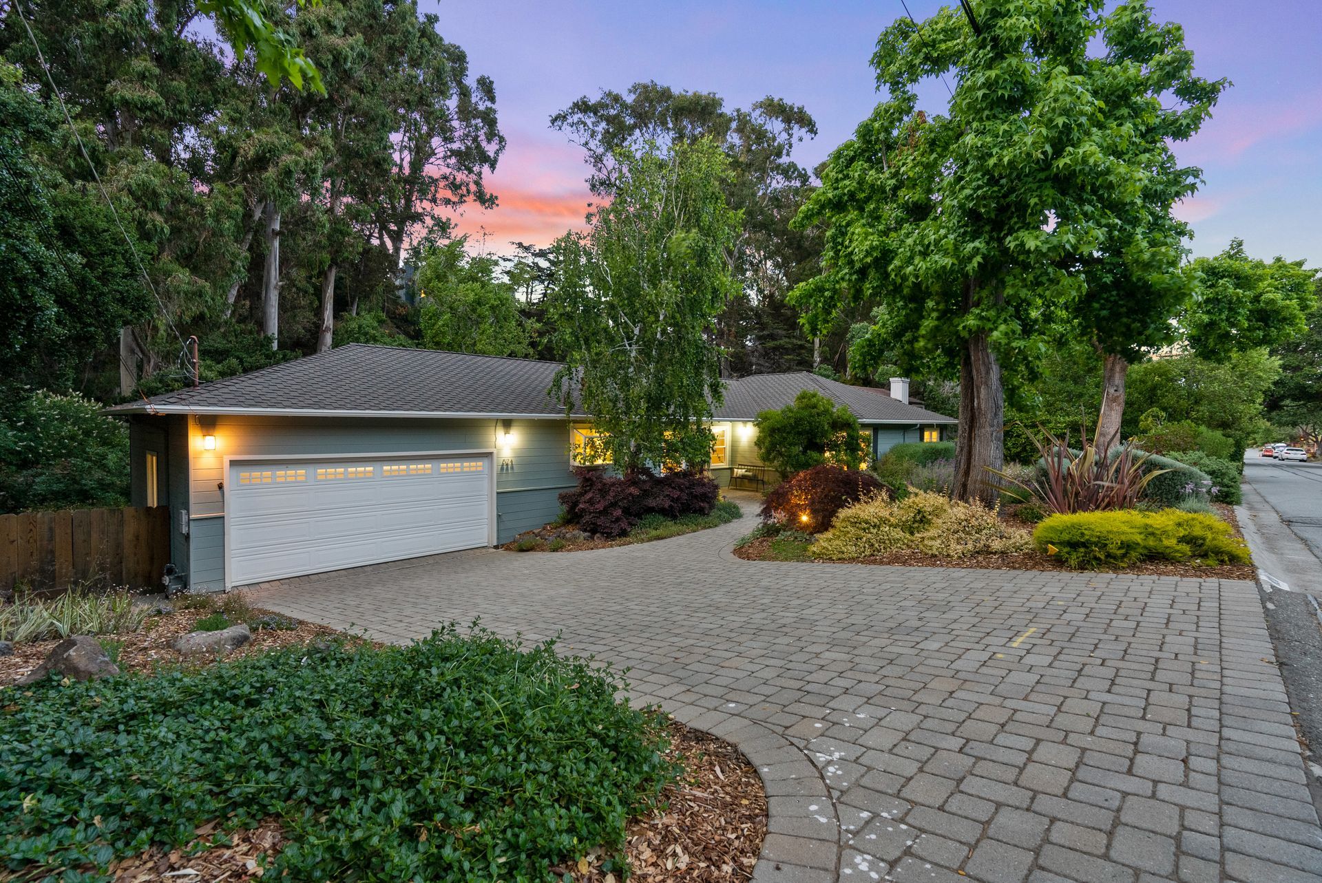 A house with a garage and a driveway is for sale.