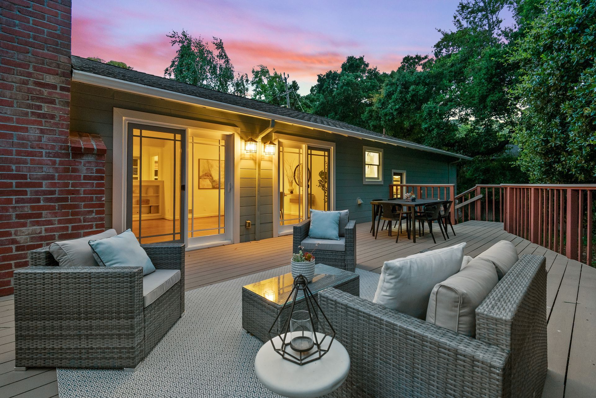 There is a large deck with a couch and chairs on it.