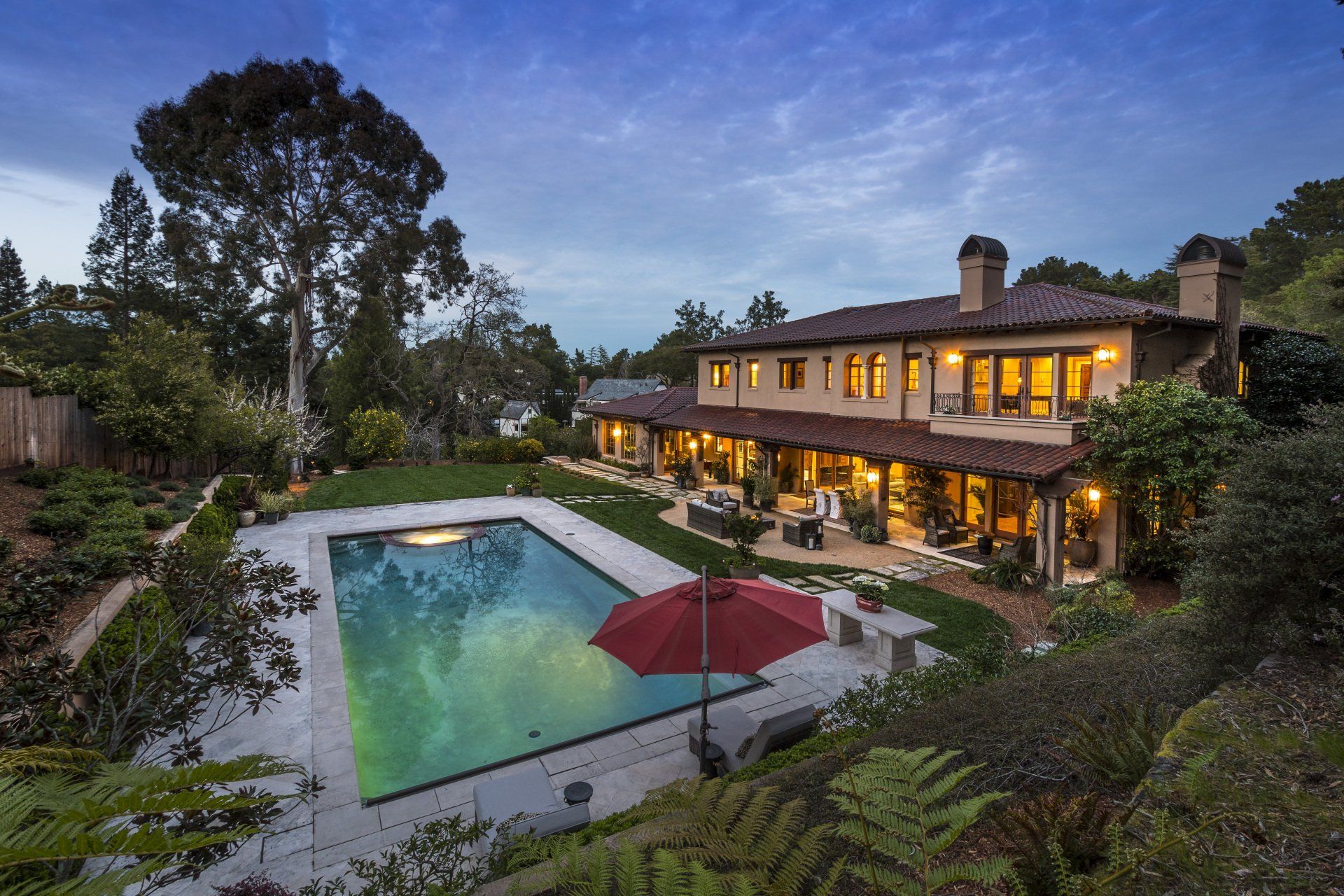 A large house with a large swimming pool in front of it