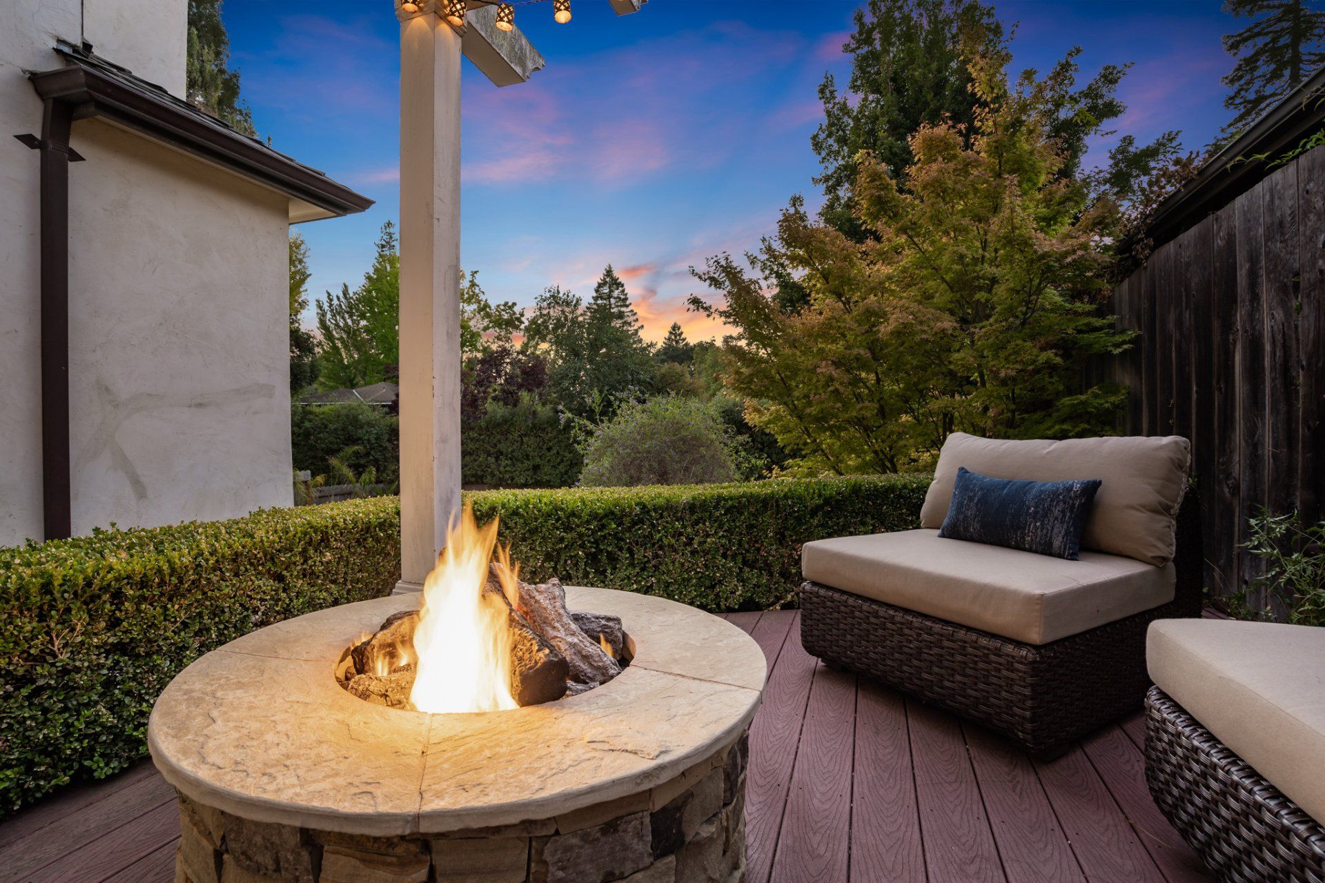 There is a fire pit in the middle of the patio.