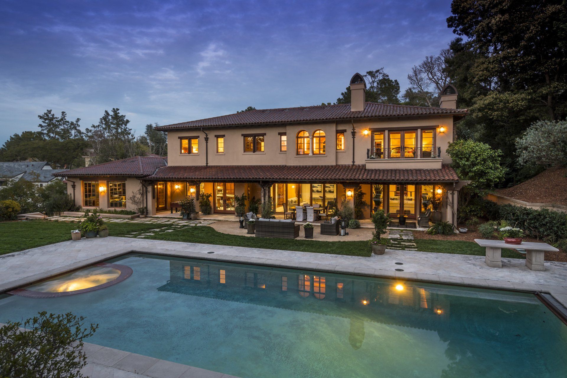 A large house with a large swimming pool in front of it