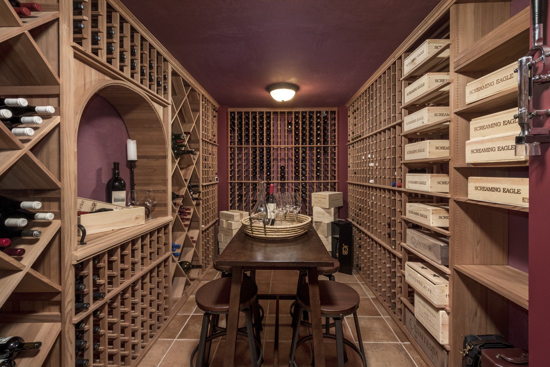 A wine cellar with wooden shelves and a table