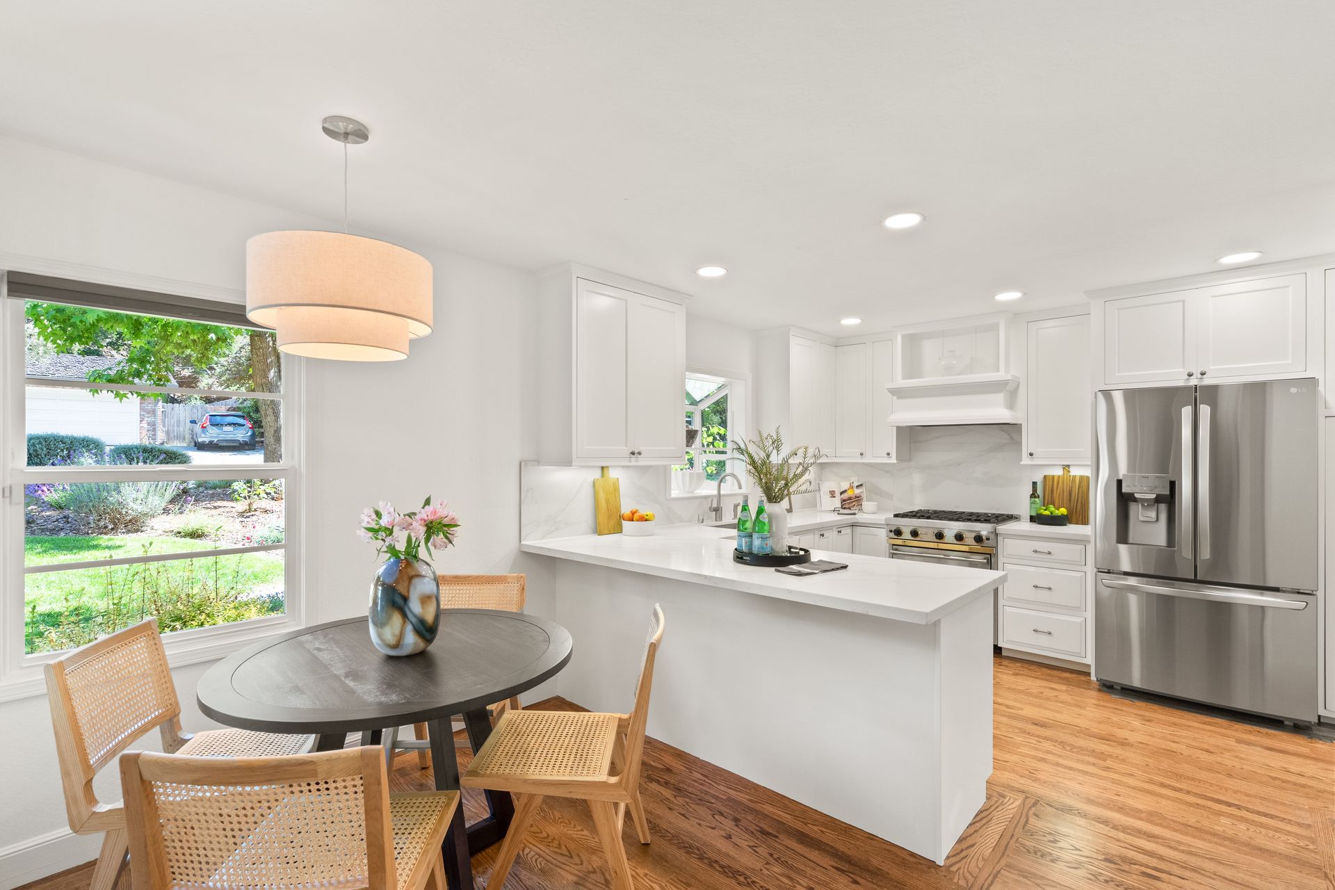 A kitchen with a table and chairs in it and a refrigerator.