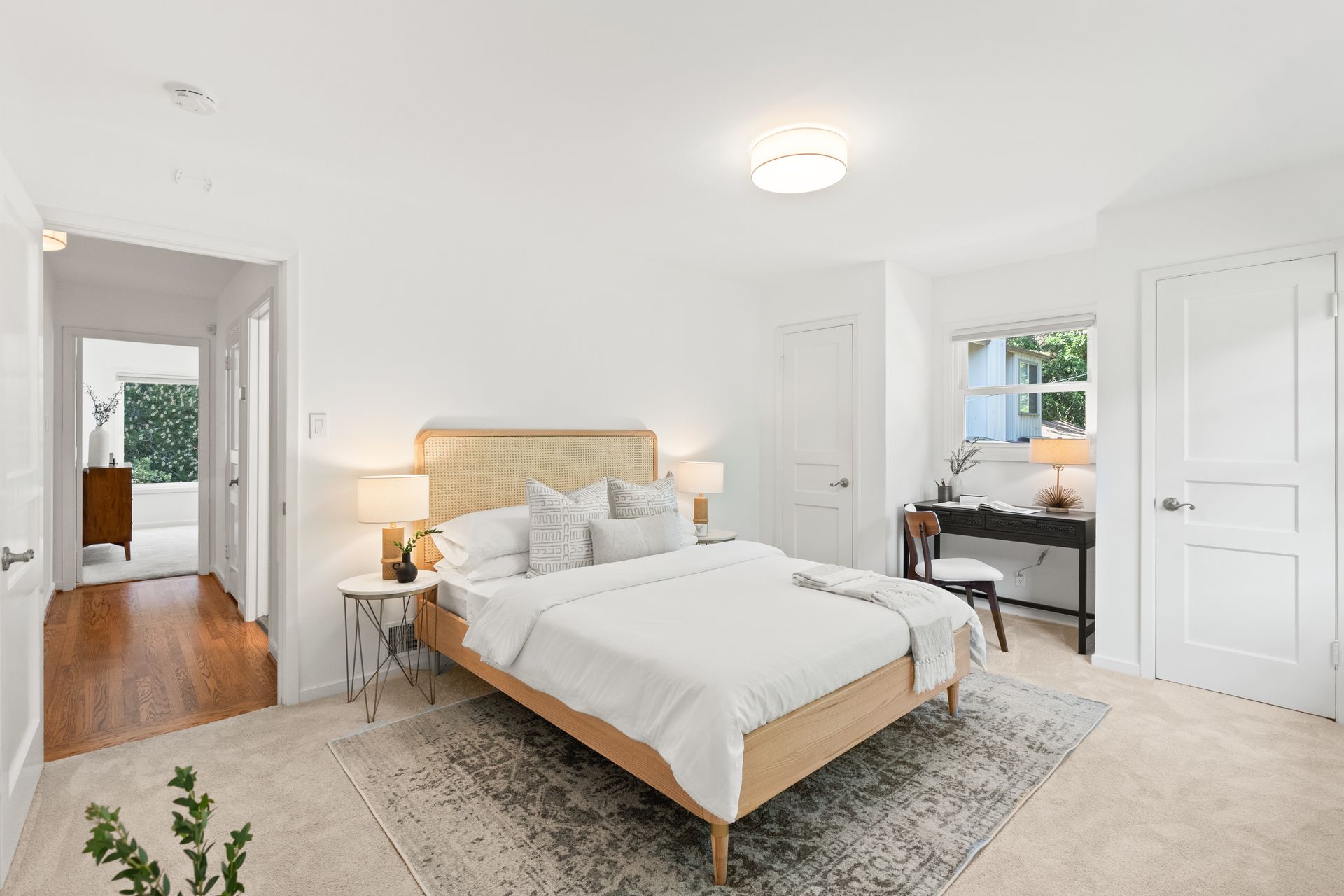 A bedroom with a bed and a rug.