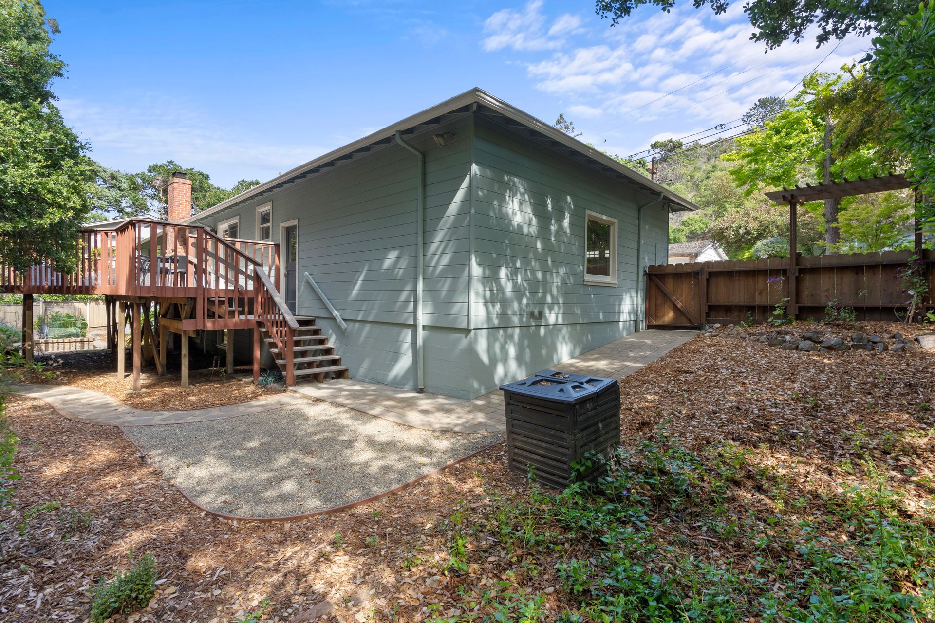 The back of a house with a deck and stairs.