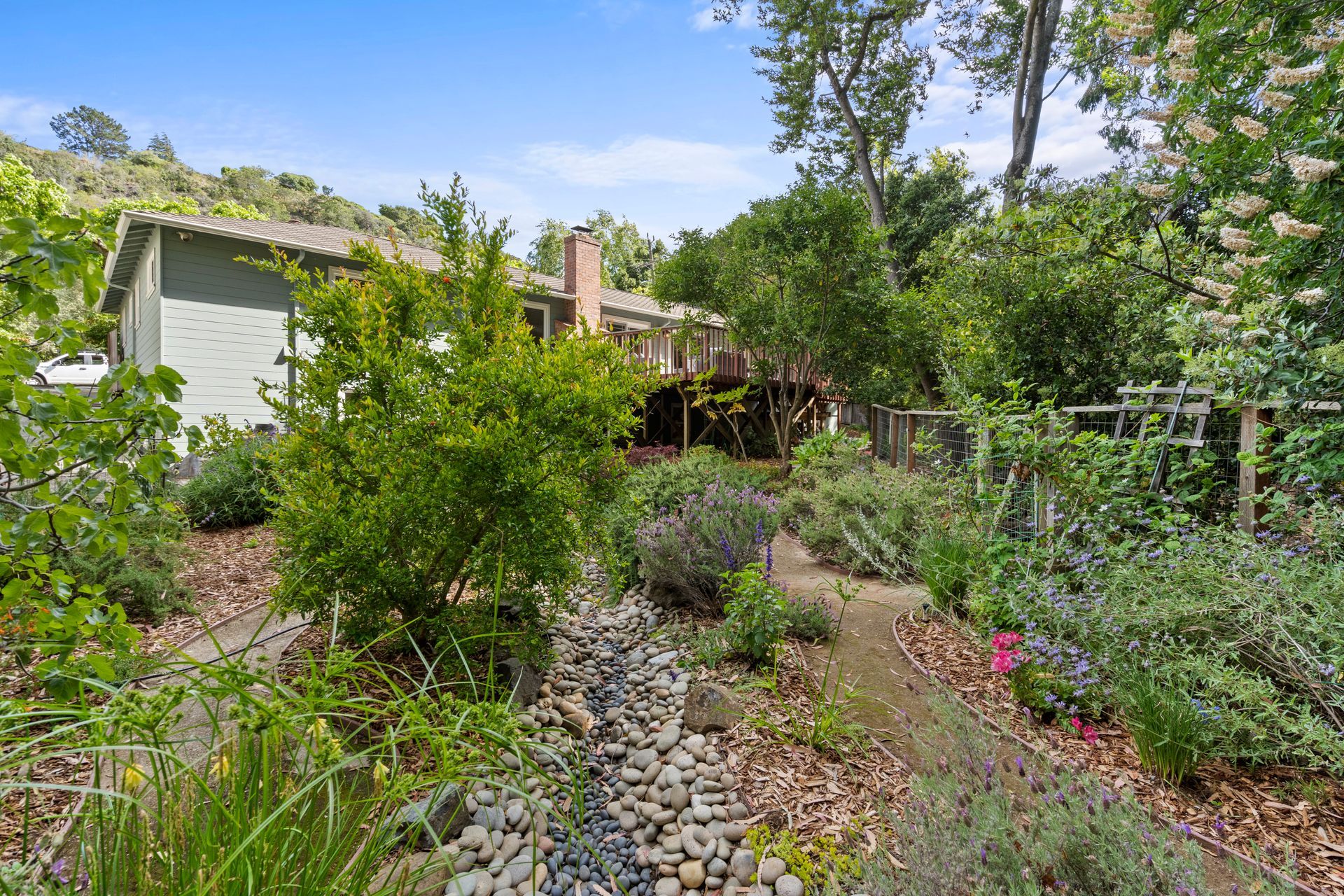 There is a house in the background and a garden in the foreground.