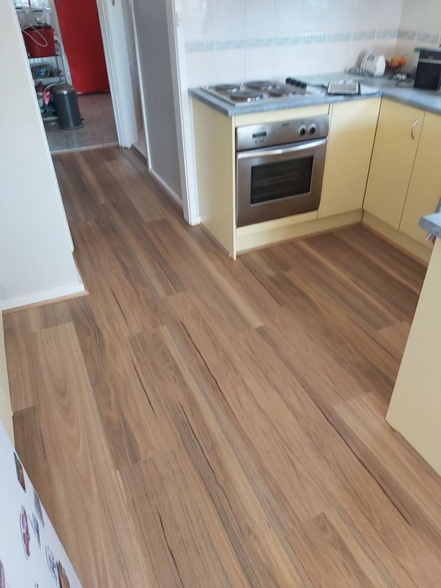 A Kitchen With Wooden Floors and a Stove — Canberra Floor Coverings in Queanbeyan, NSW