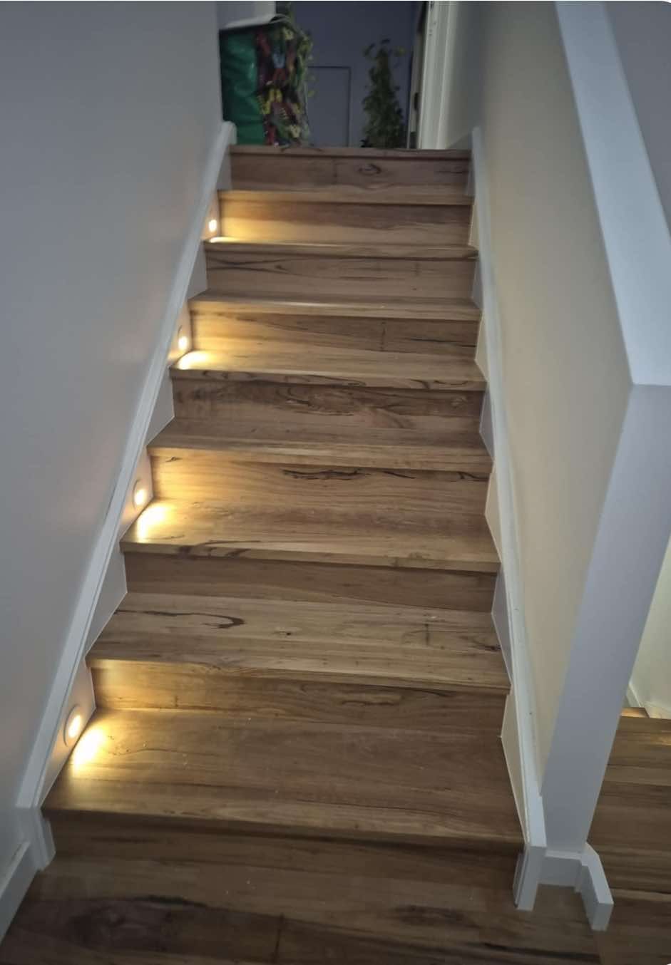 Wooden Stairs with Built-In Lights, White Walls, and A Bannister, Leading Upwards — Canberra Floor Coverings in Queanbeyan West, NSW