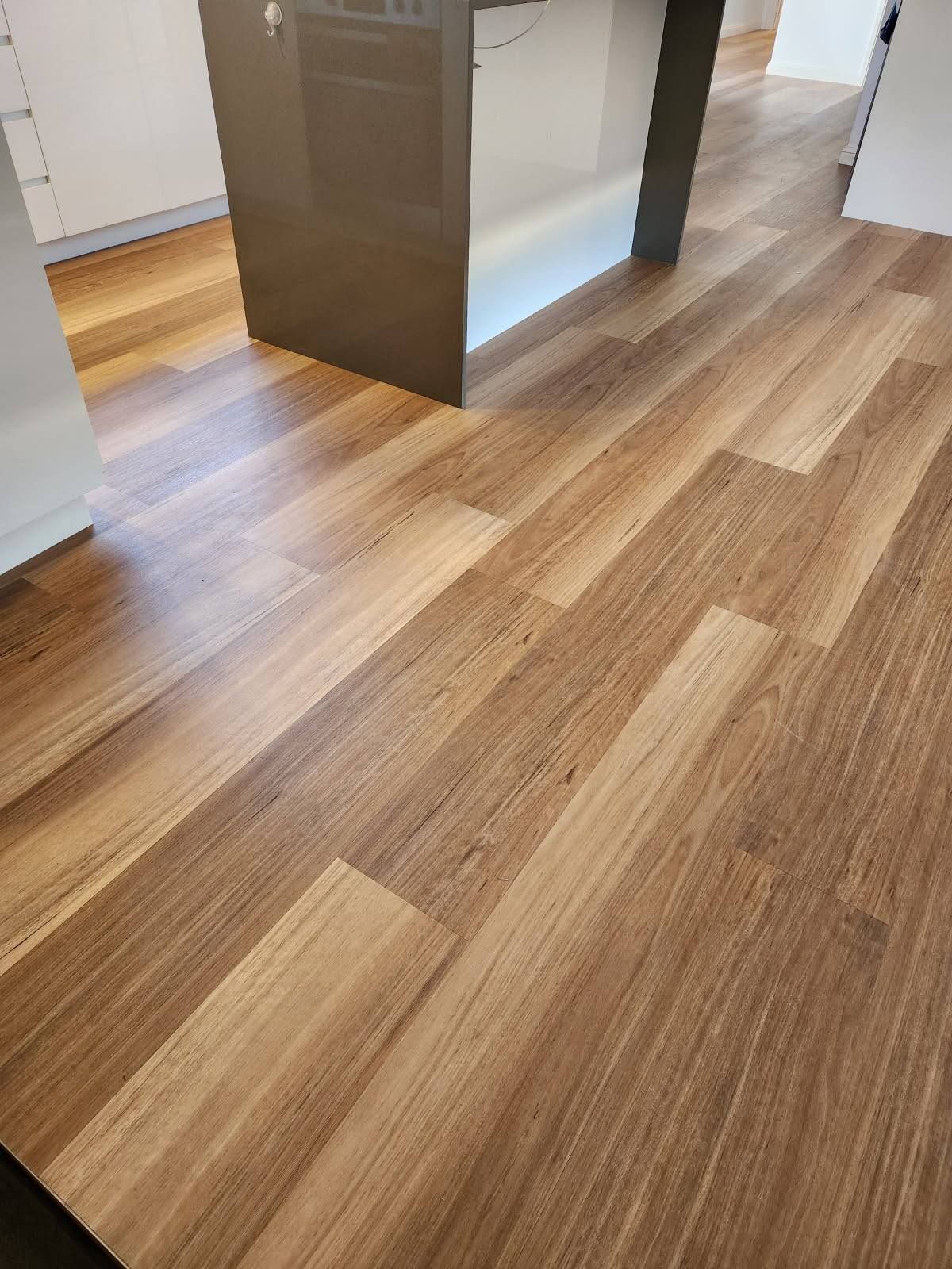 Wood Floor, Angled Planks, in A Room with A Kitchen Island. Brown and Beige Tones — Canberra Floor Coverings in Queanbeyan West, NSW