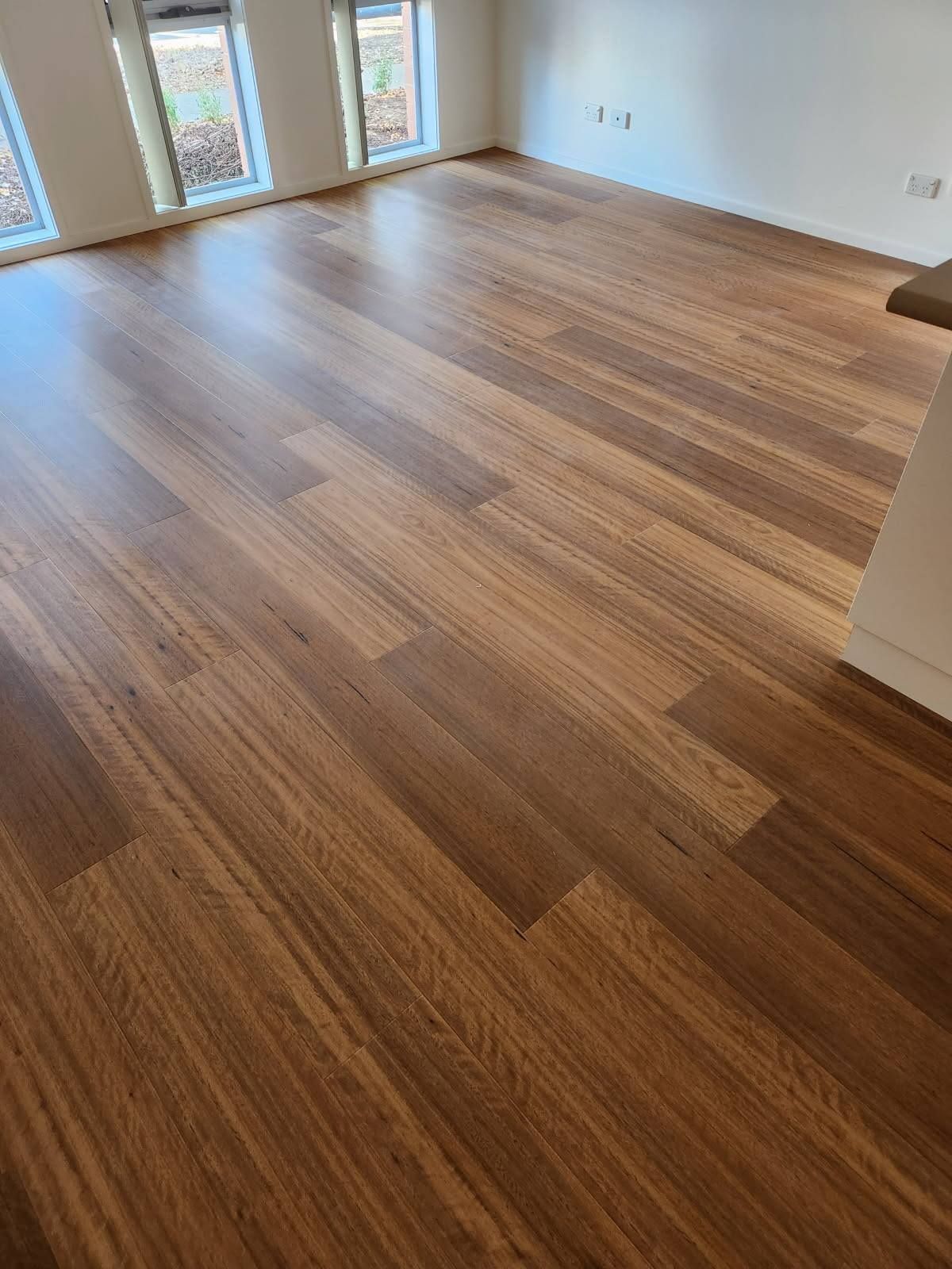 Wooden Hardwood Floor, Medium Brown Colour, in An Empty Room — Canberra Floor Coverings in Queanbeyan West, NSW