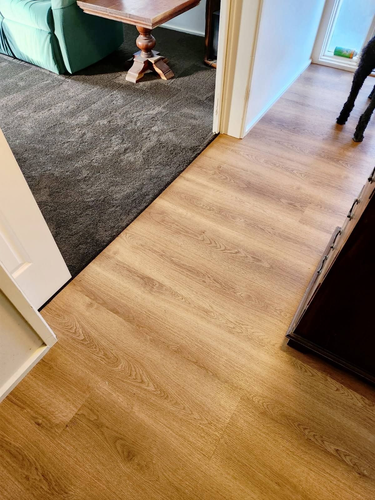 Transition Between a Dark Grey Carpet and Light Wood-Look Flooring — Canberra Floor Coverings in Queanbeyan West, NSW