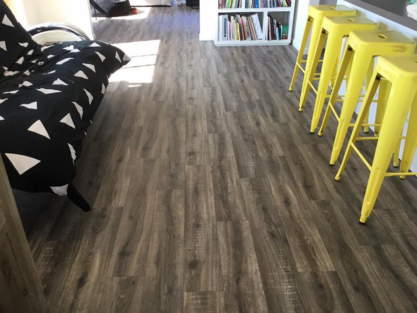 A Living Room With a Futon and Yellow Stools — Canberra Floor Coverings in Queanbeyan, NSW
