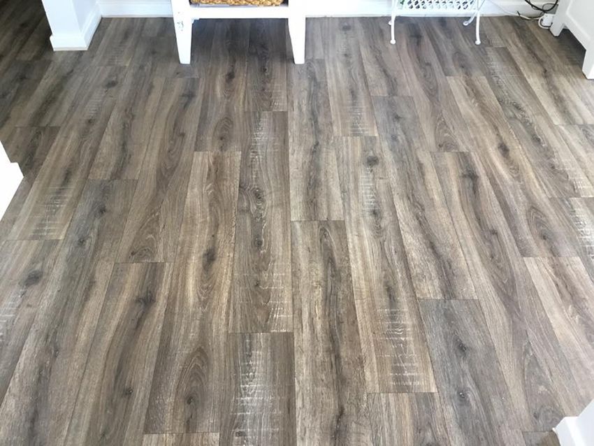 A Living Room With a Wooden Floor and a White Bench — Canberra Floor Coverings in Bungendore, NSW