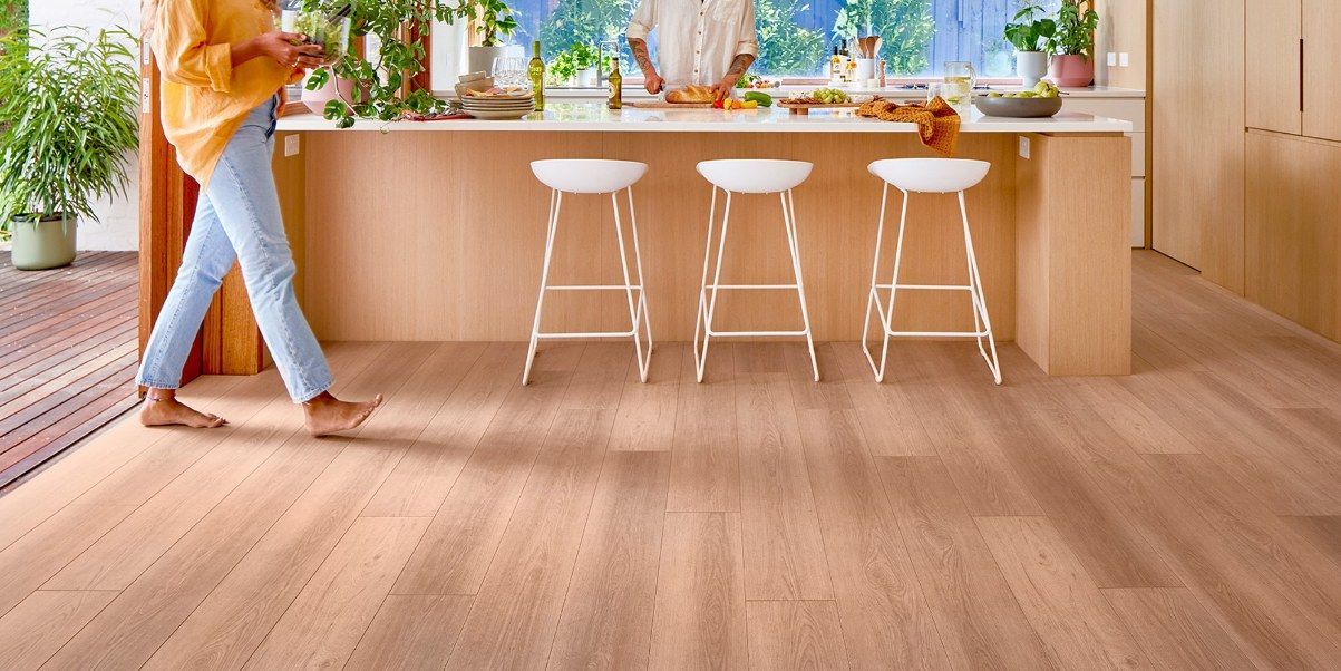 Person Walking on Wood Floor in Kitchen — Canberra Floor Coverings in Queanbeyan West, NSW