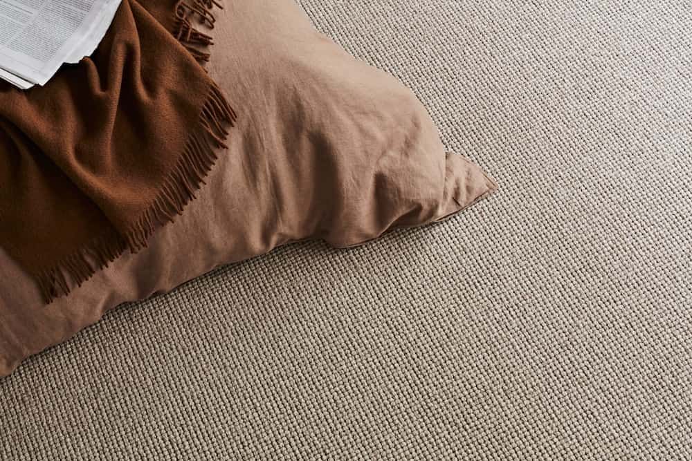 Beige Carpet with A Brown Pillow and Blanket — Canberra Floor Coverings in Queanbeyan West, NSW