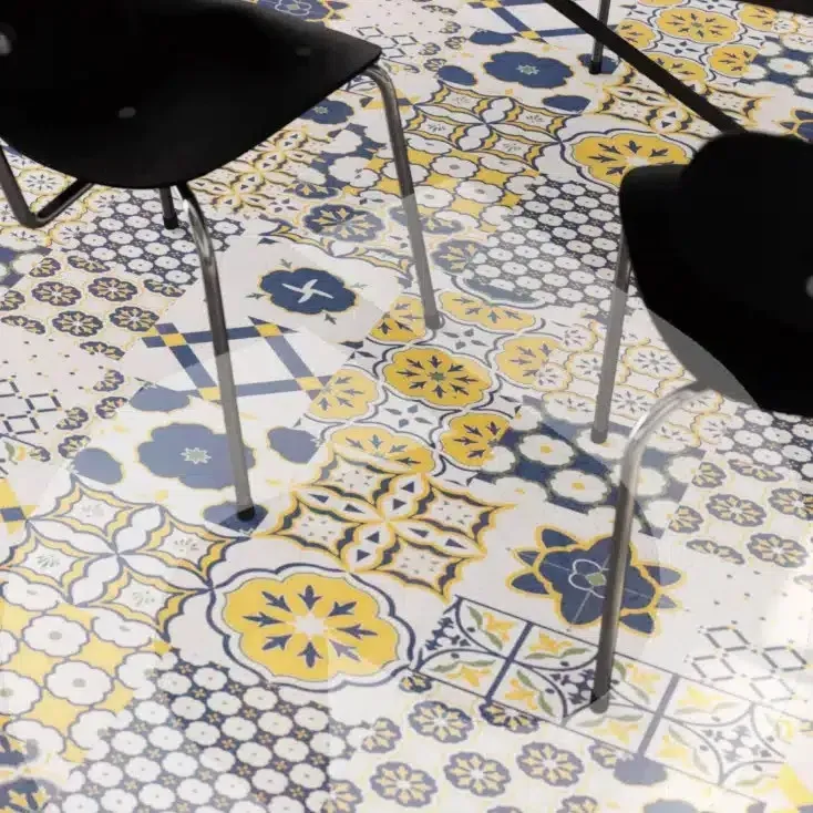 Black Chairs at A Table with A Colourful Mosaic Tile Floor in Blue, Yellow, and White Pattern — Canberra Floor Coverings in Queanbeyan West, NSW