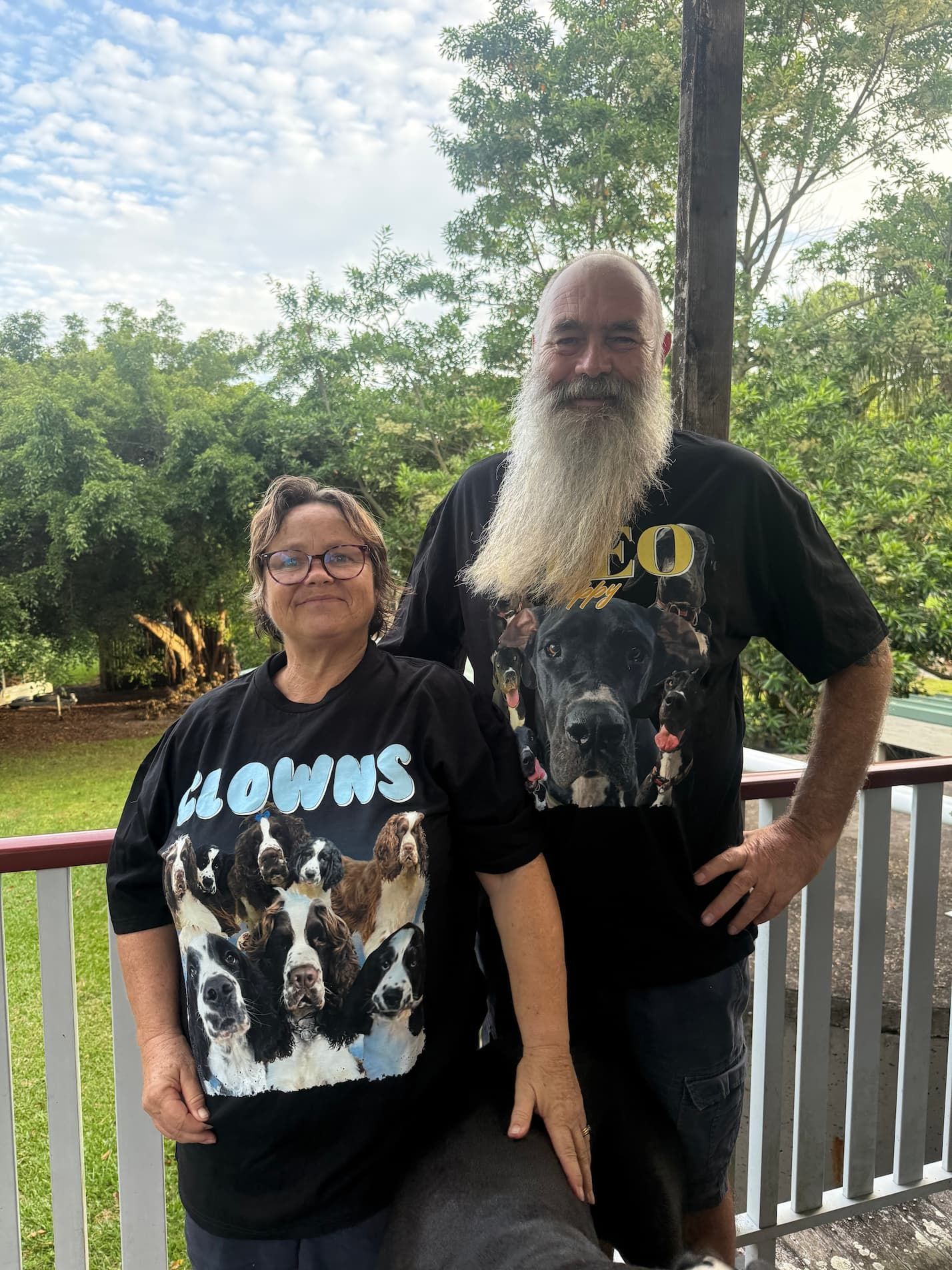 A Man And A Woman Are Standing Next To Each Other On A Porch — Yeppoon Boarding Kennels & Cattery In Farnborough, QLD