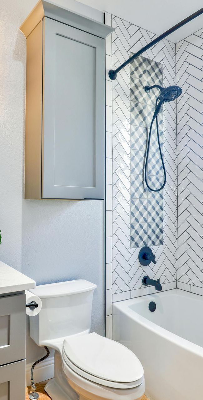 A bathroom with a toilet , sink , bathtub and shower.