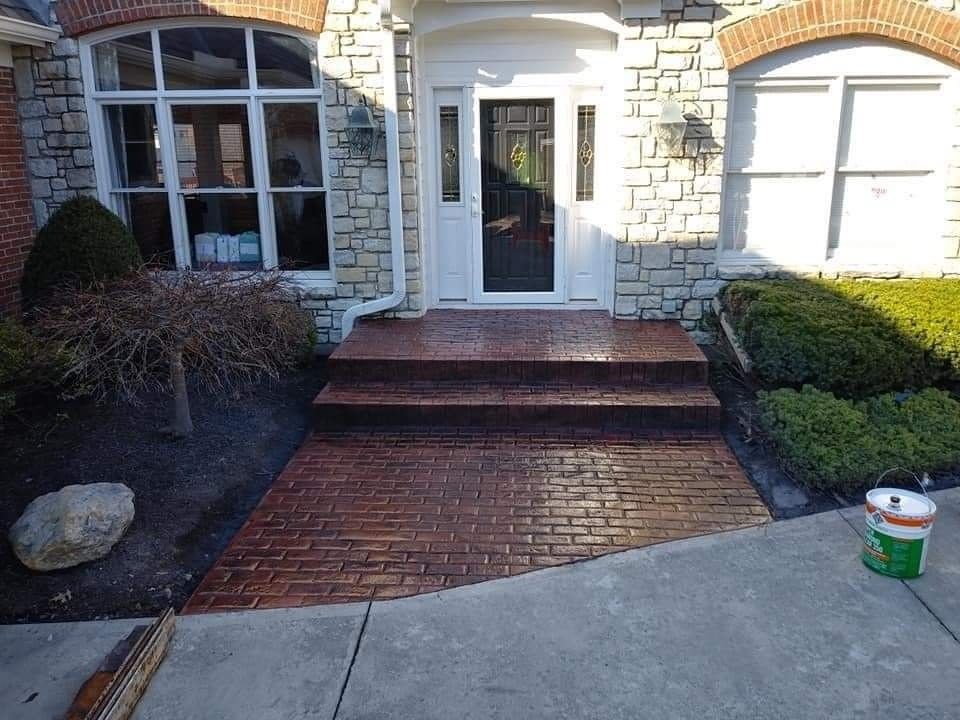 A brick walkway leading to the front door of a house