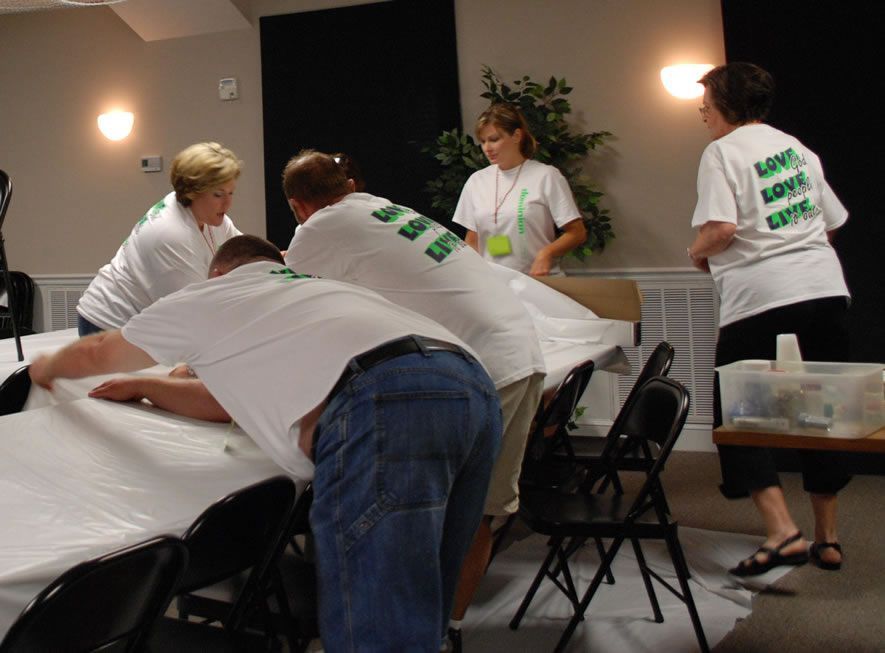 A group of people wearing white shirts that say save a life