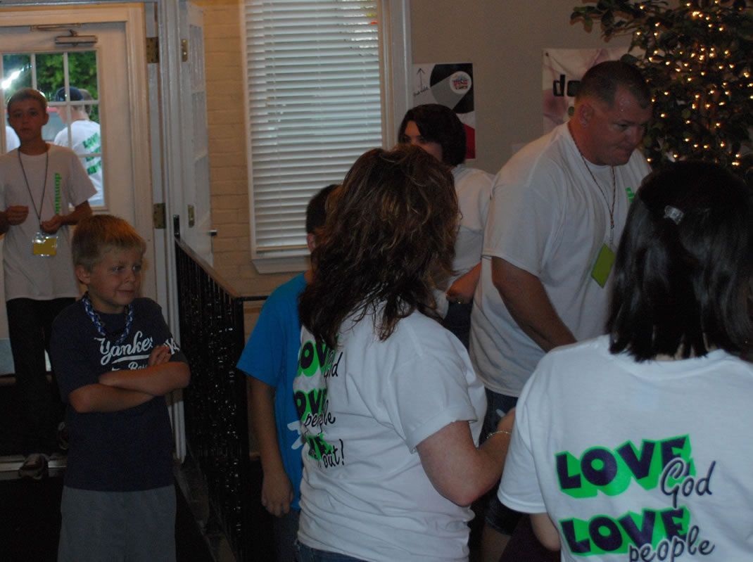 A group of people wearing shirts that say love god love people